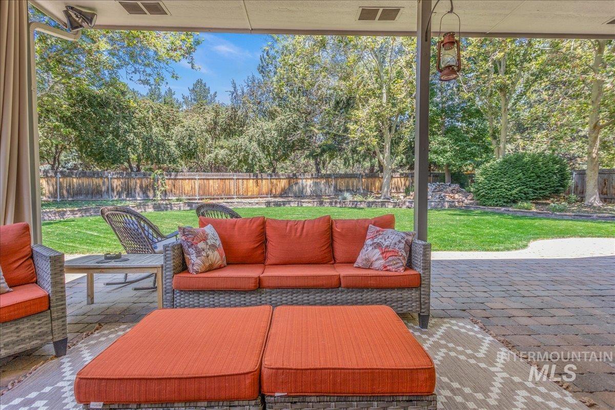 Fenced backyard featuring outdoor lounge area and a patio