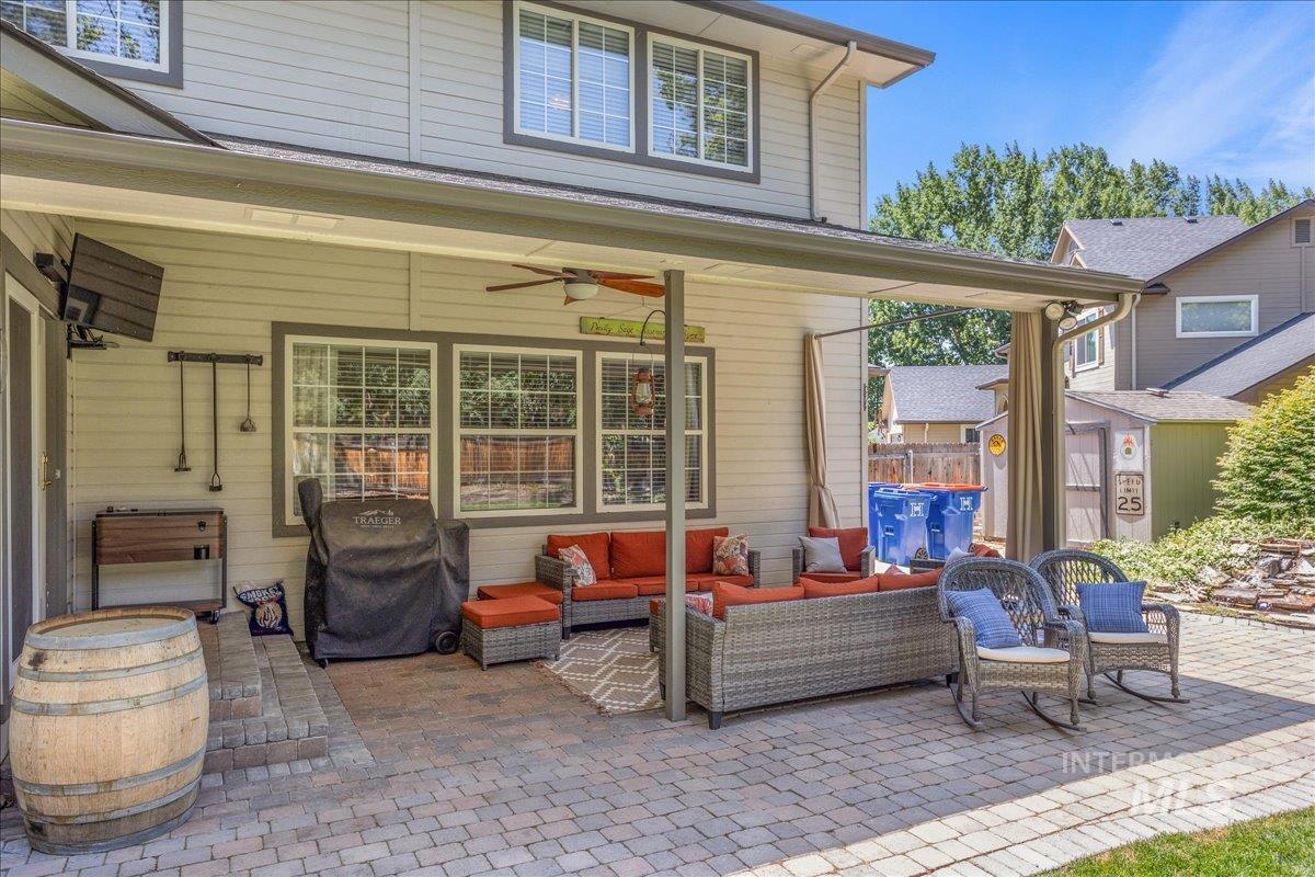 View of patio / terrace featuring an outdoor living space, ceiling fan, a storage shed, and grilling area