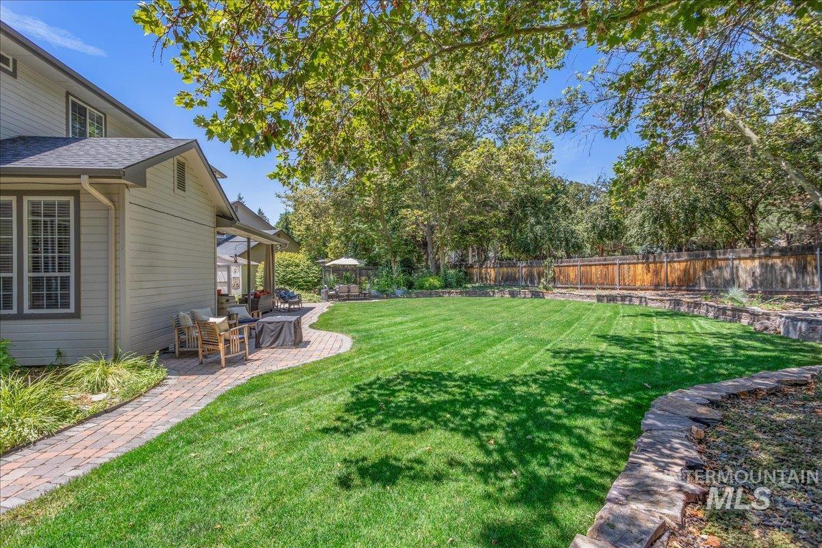 Fenced backyard featuring a patio and a gazebo