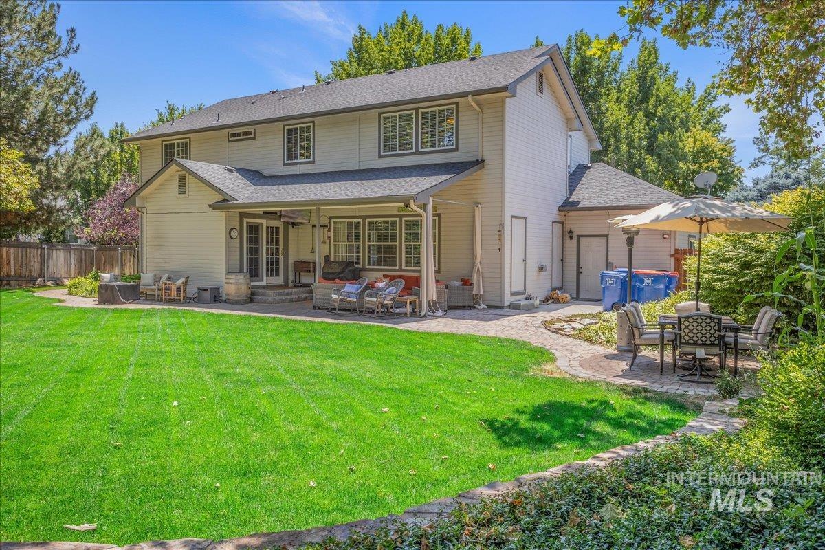 Rear view of house with a patio area, roof with shingles, outdoor lounge area, and french doors