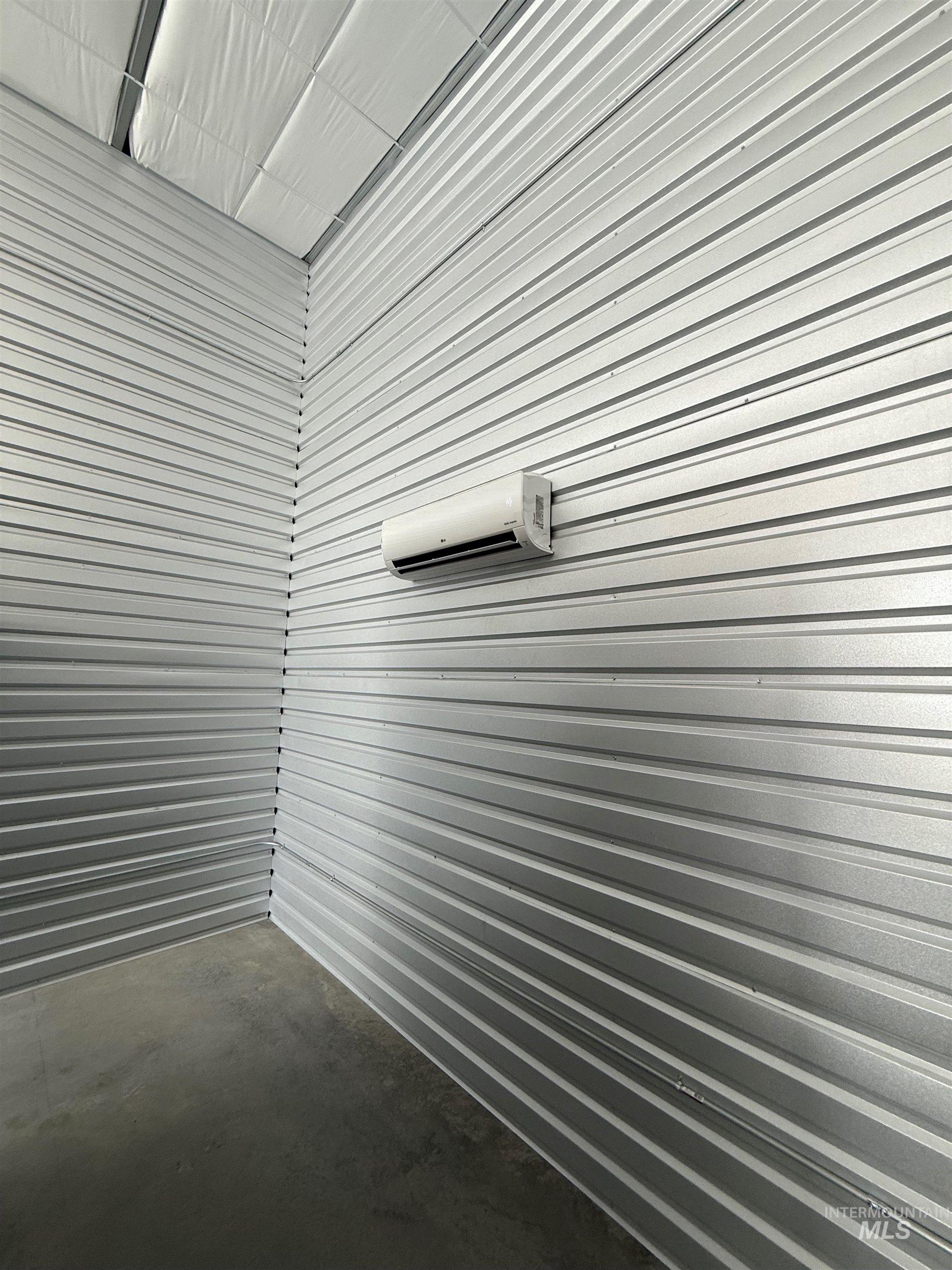 Garage featuring a wall mounted AC