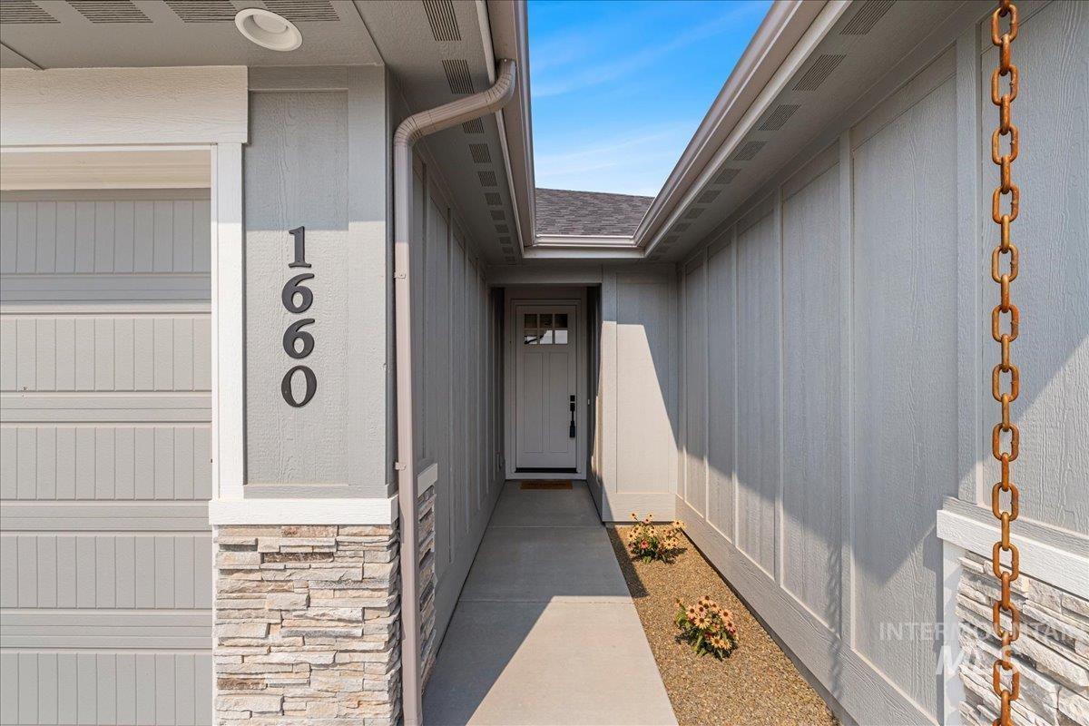 Property entrance featuring stone siding