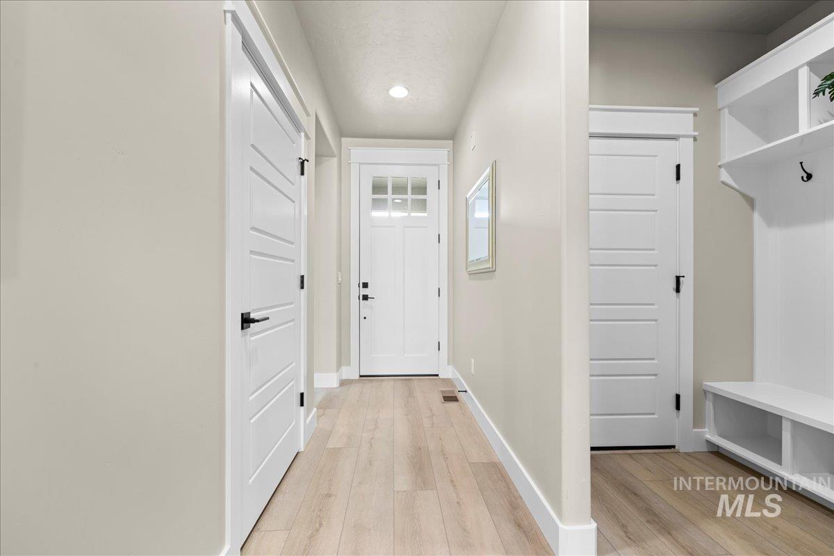 Mudroom with light wood-type flooring and recessed lighting