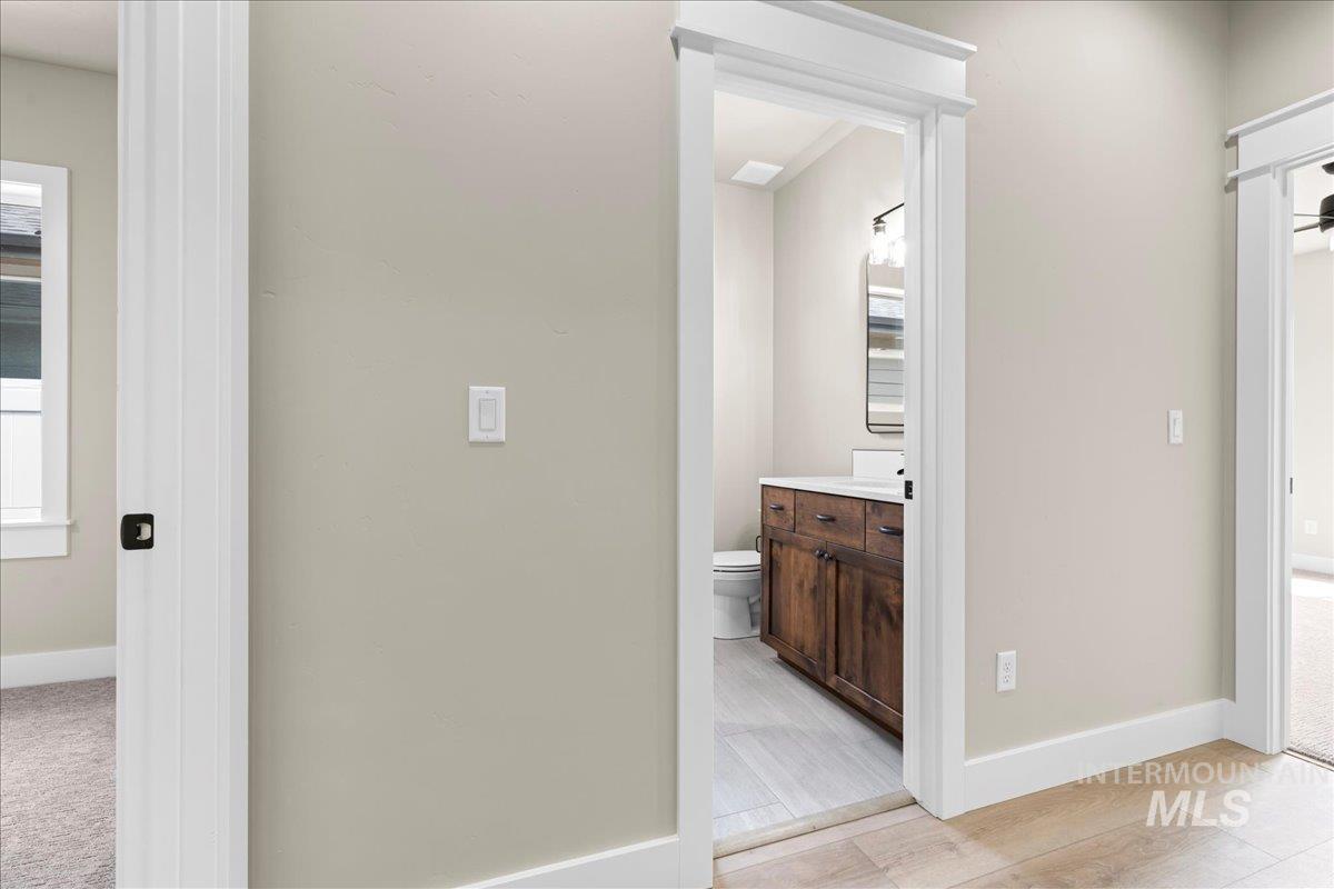 Half bathroom with vanity and light wood-style floors