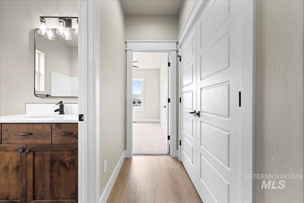 Hall featuring baseboards and light wood finished floors
