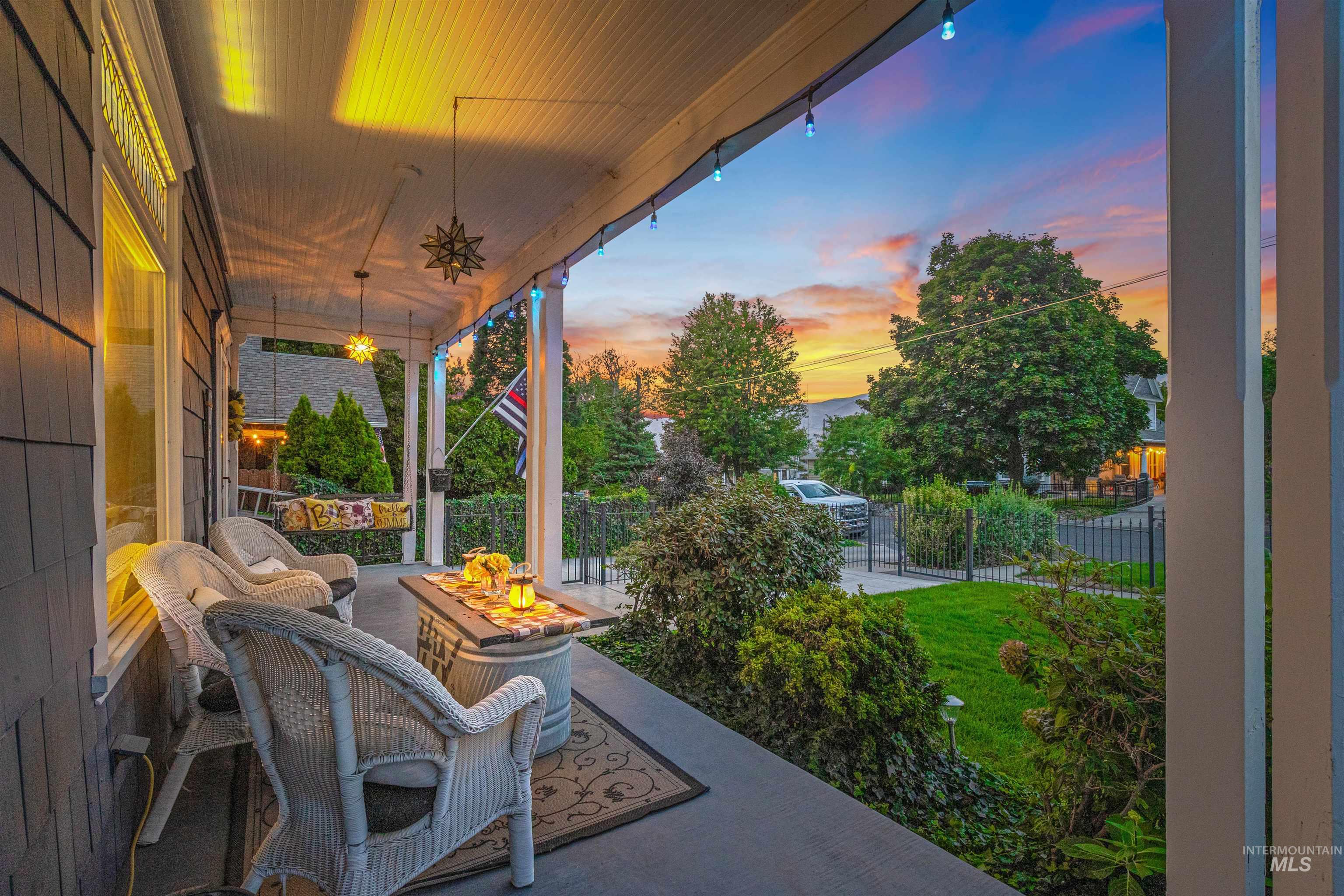 Covered porch featuring an outdoor fire pit