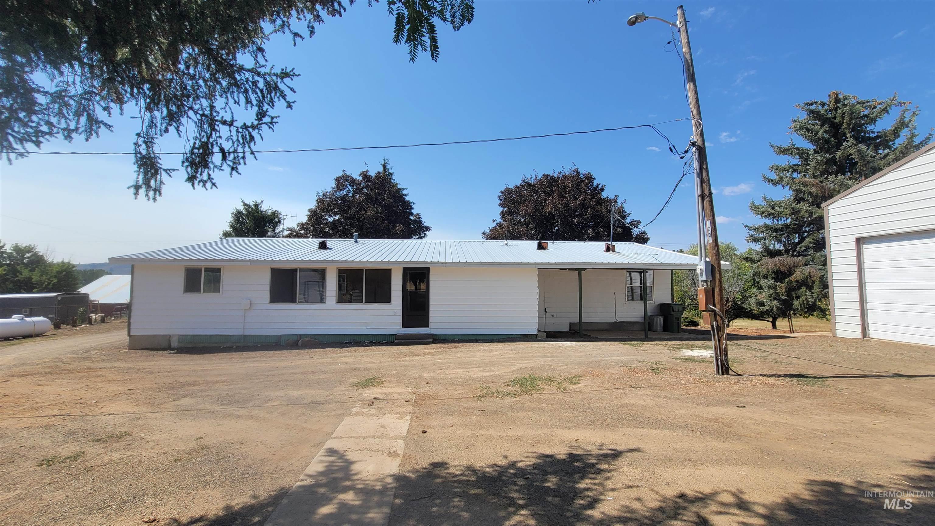 View of front of house with a metal roof