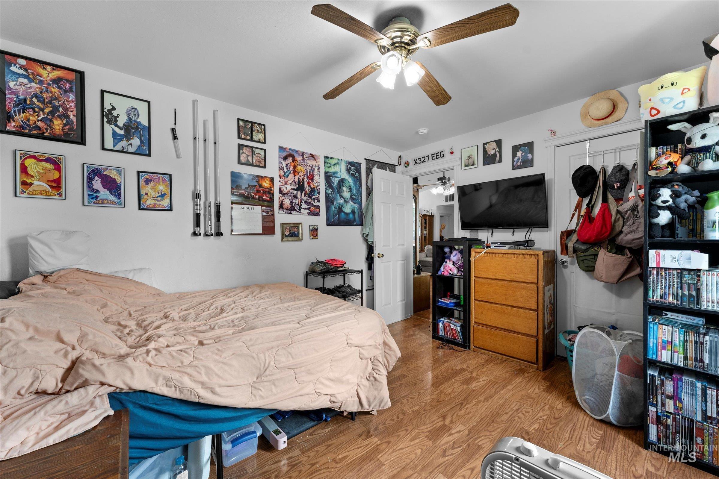 Bedroom with wood finished floors and a ceiling fan