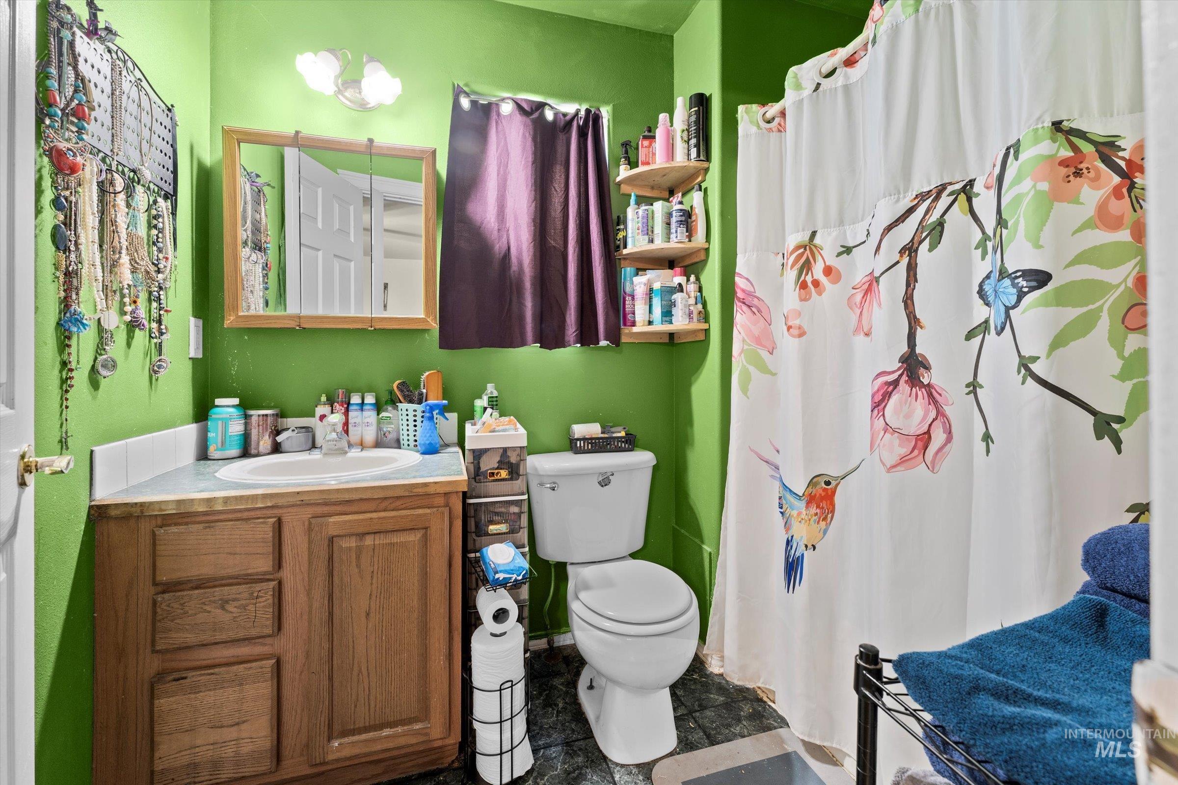 Full bath featuring vanity and curtained shower