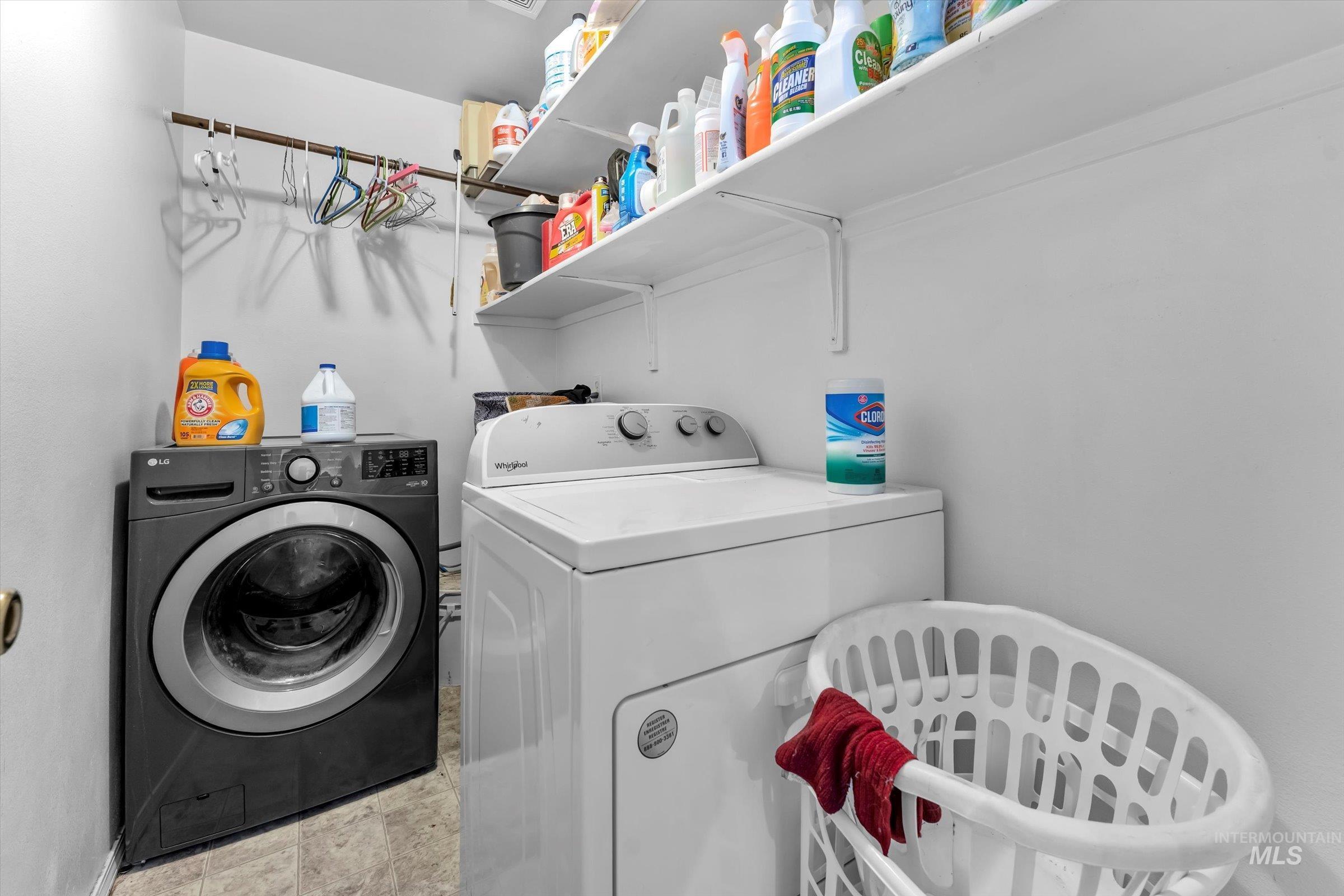 Washroom featuring washing machine and clothes dryer