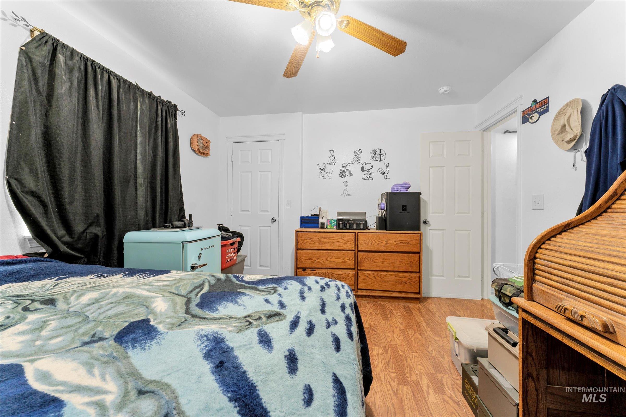 Bedroom featuring light wood-type flooring and ceiling fan