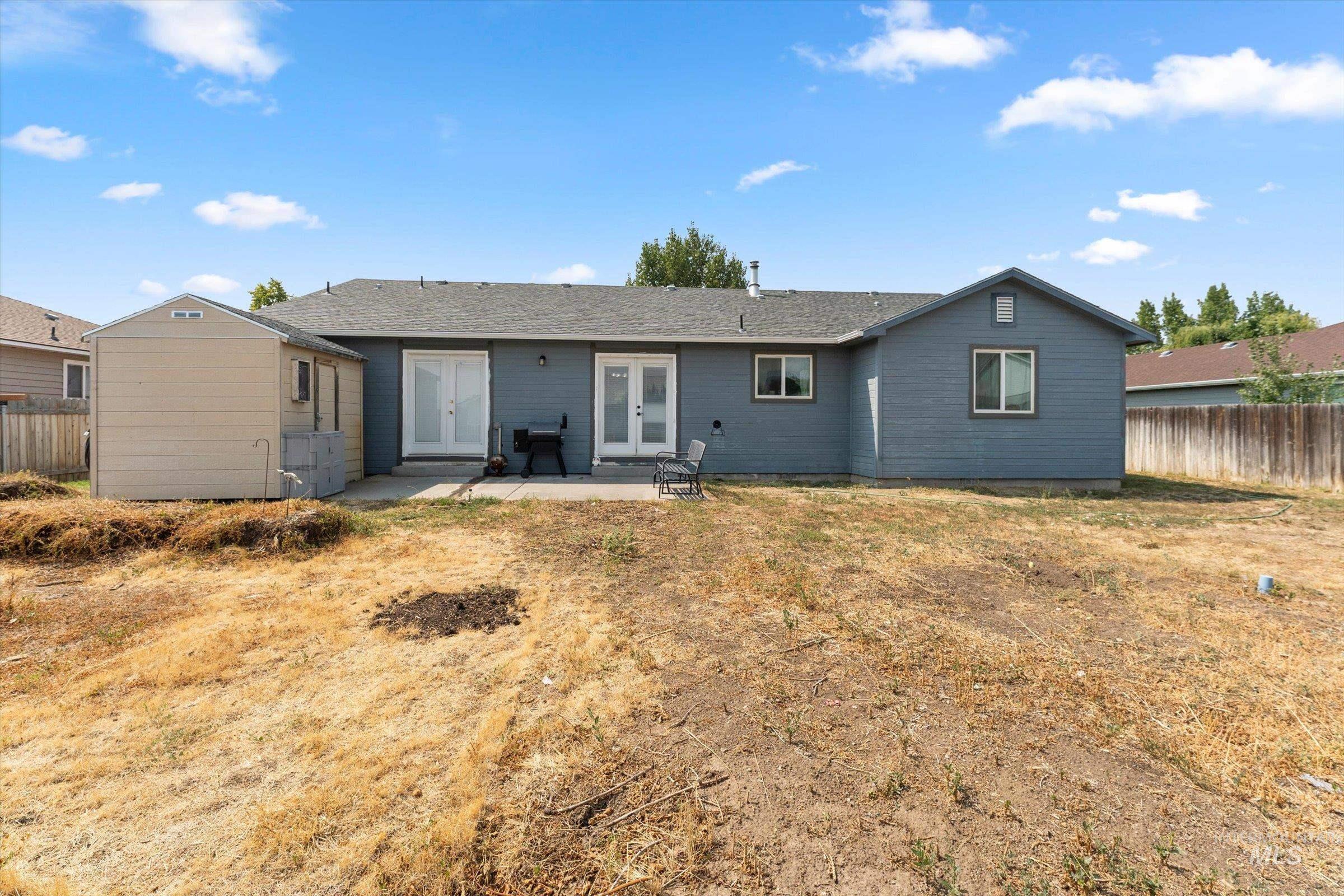 Back of property with a patio area, french doors, and a shed