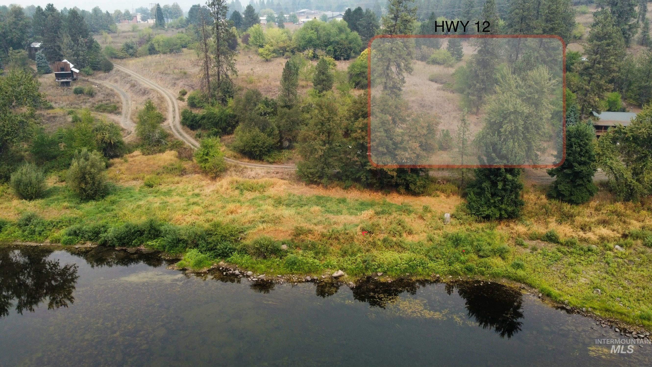 View of property location featuring property boundaries highlighted and a nearby body of water