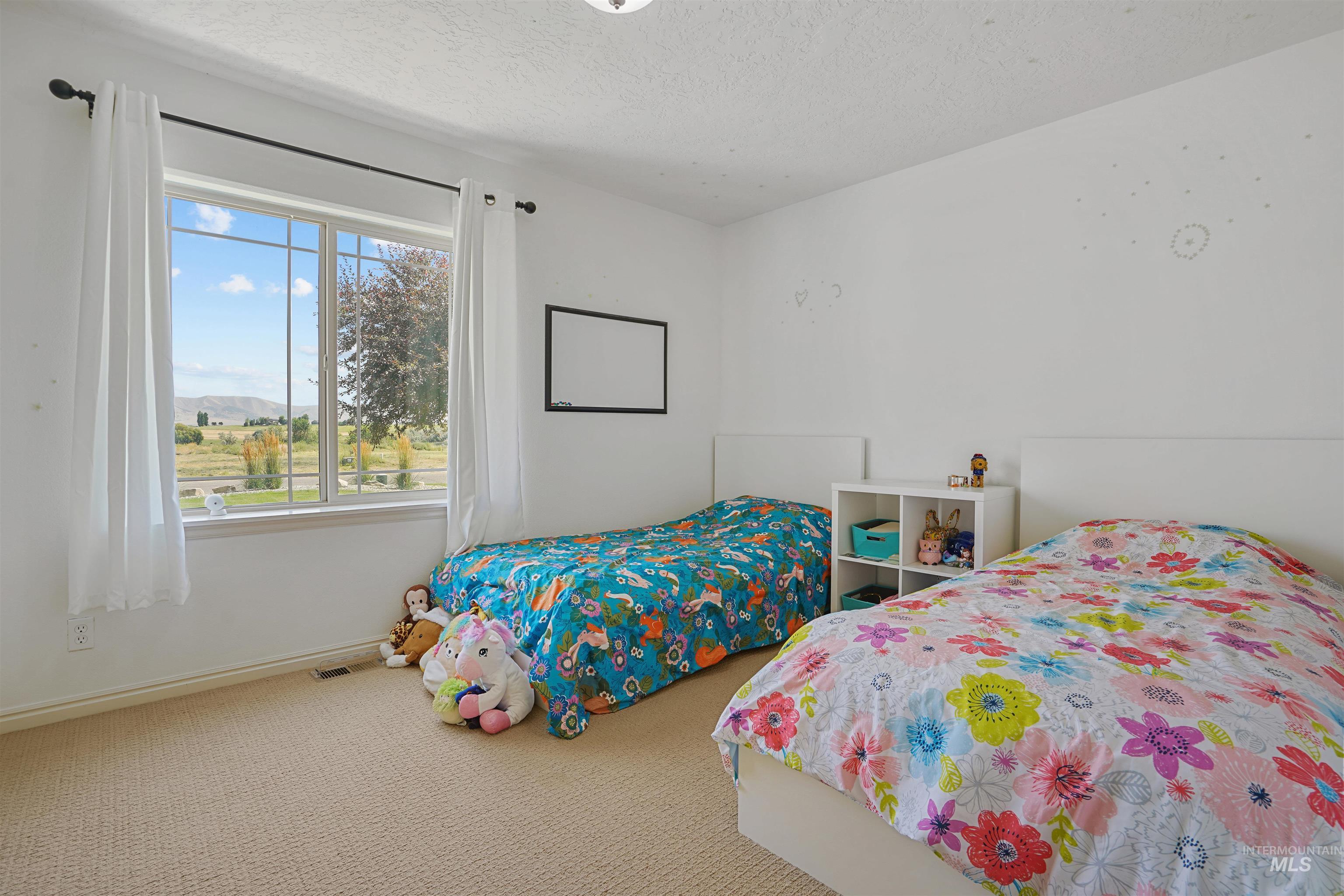 Bedroom with carpet flooring and a textured ceiling