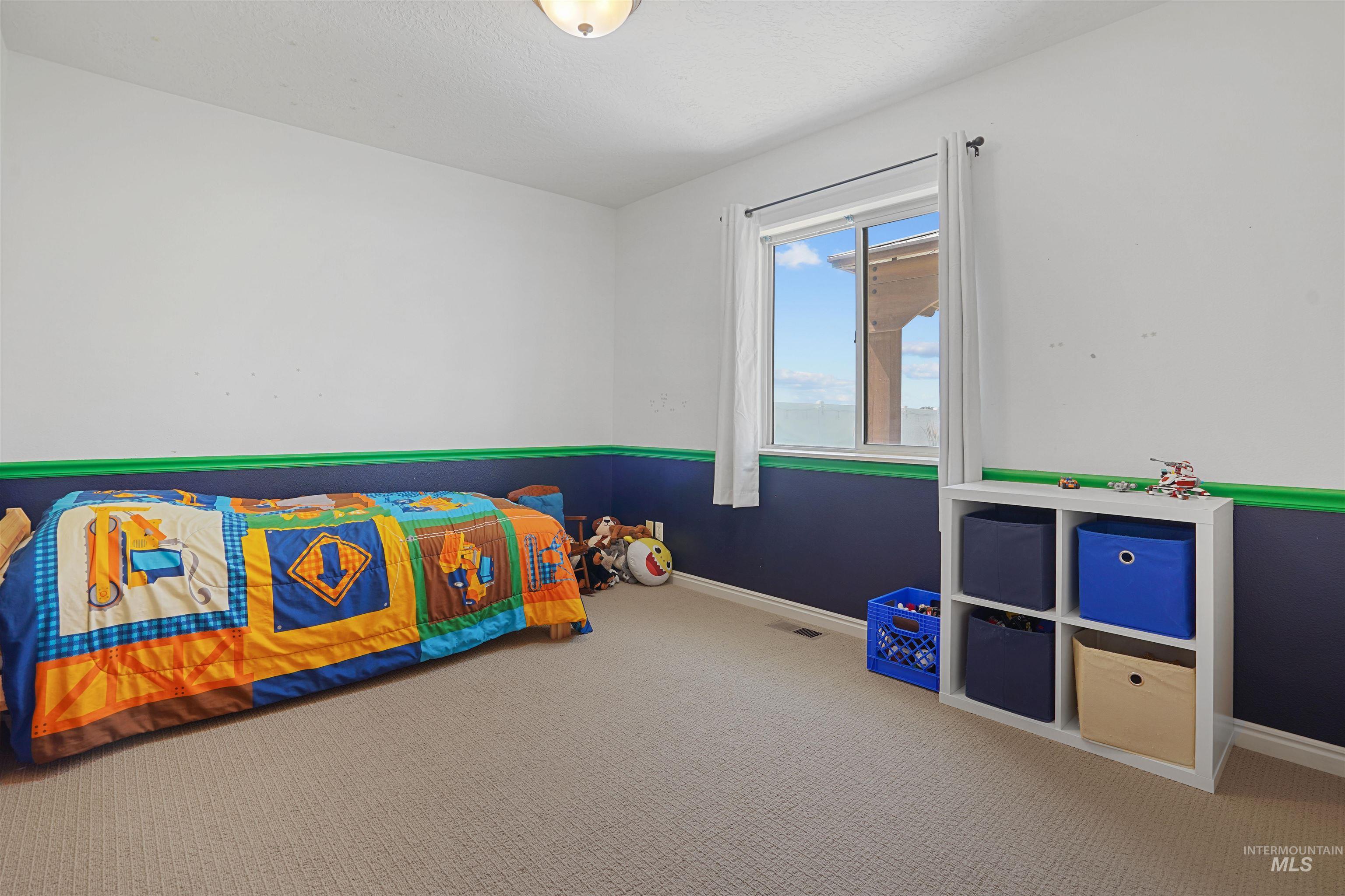 Unfurnished bedroom featuring baseboards and carpet
