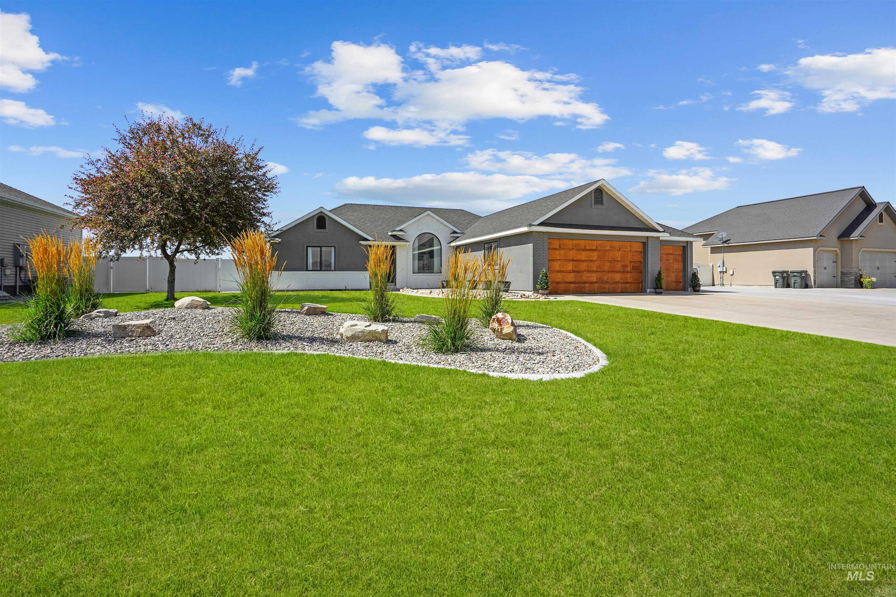 Ranch-style home featuring concrete driveway and a garage