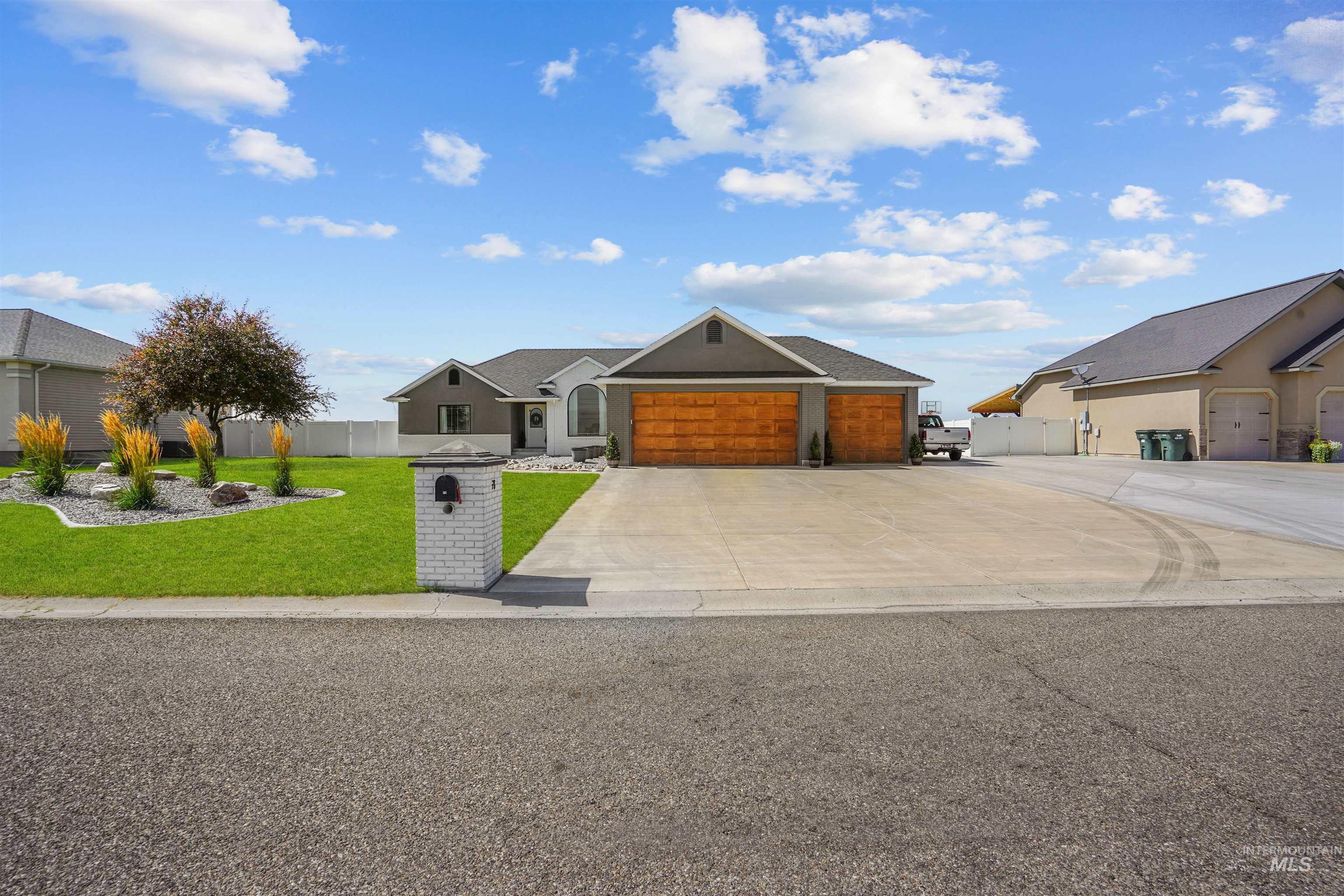 View of front of property with driveway and a garage