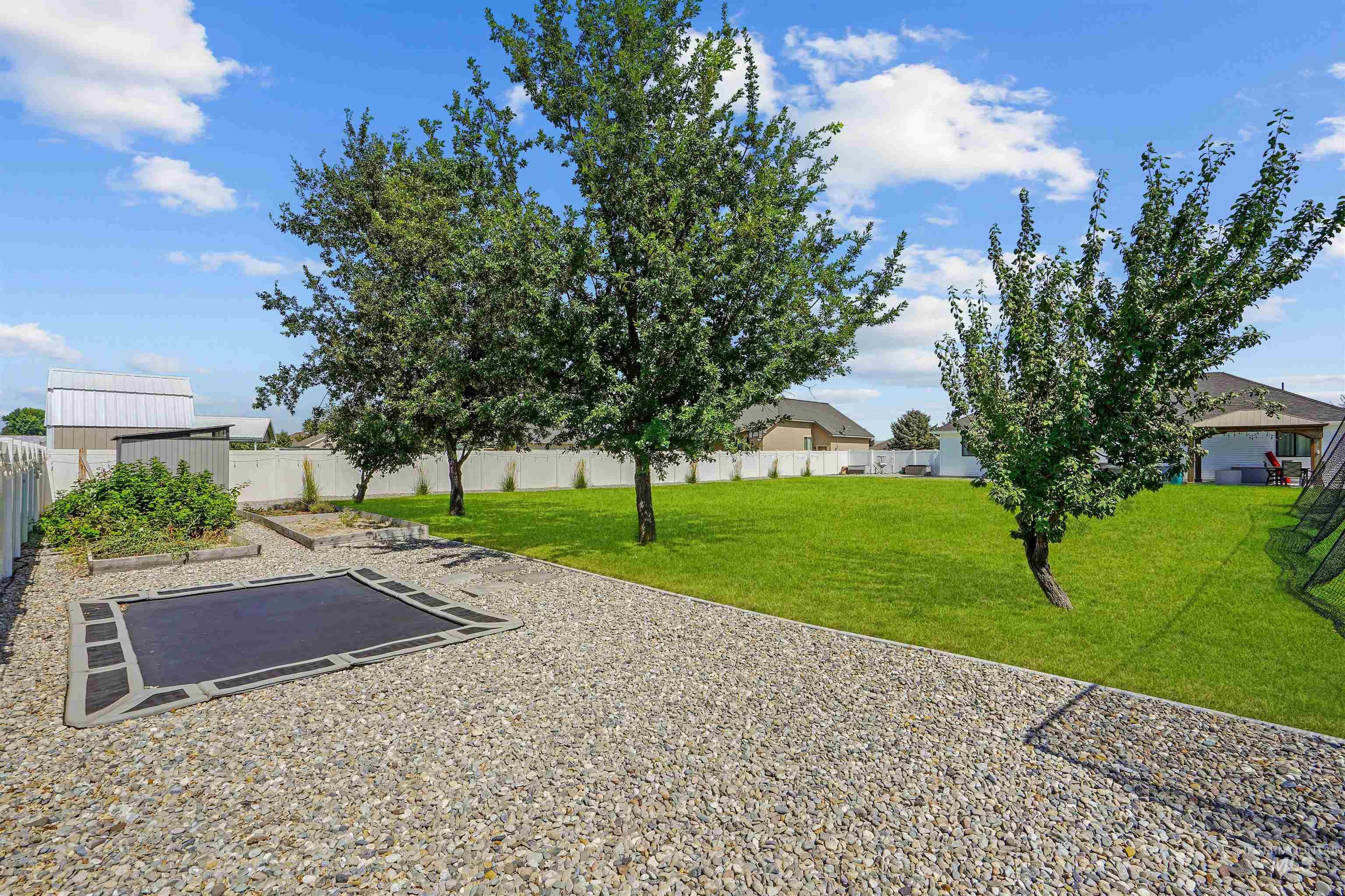 Fenced backyard with a patio area and an outdoor structure