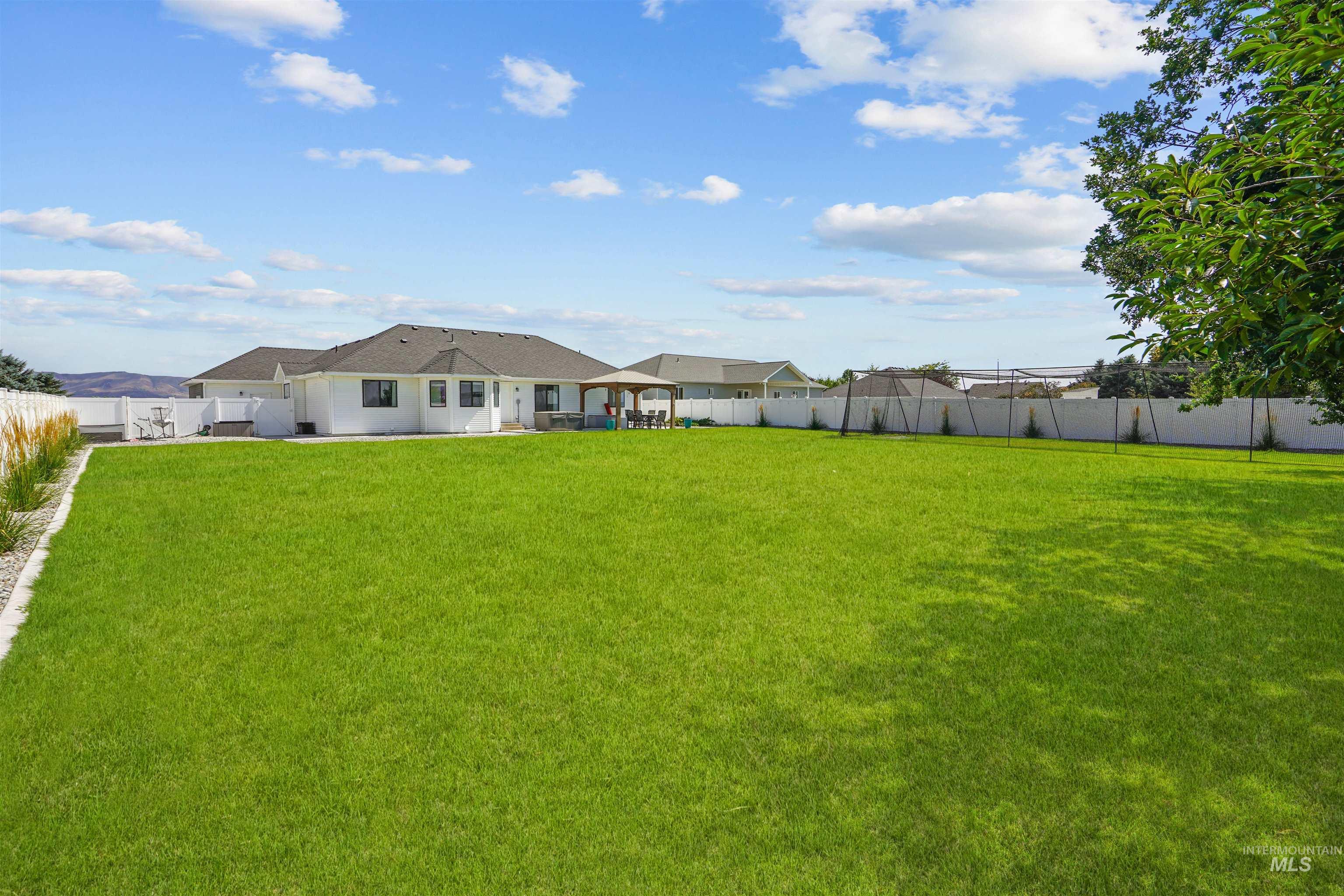 Fenced backyard with a patio