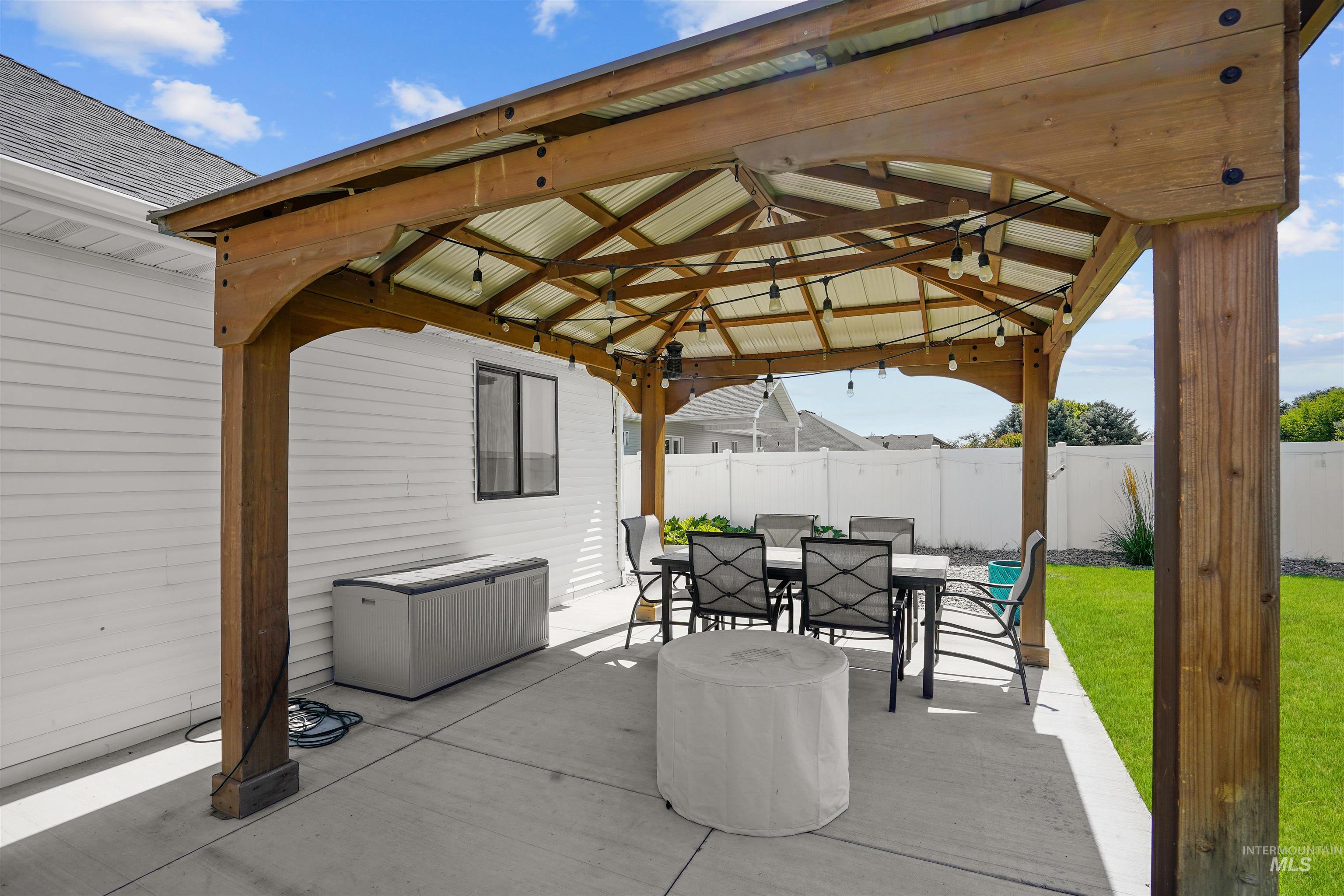 View of patio with a gazebo and outdoor dining space