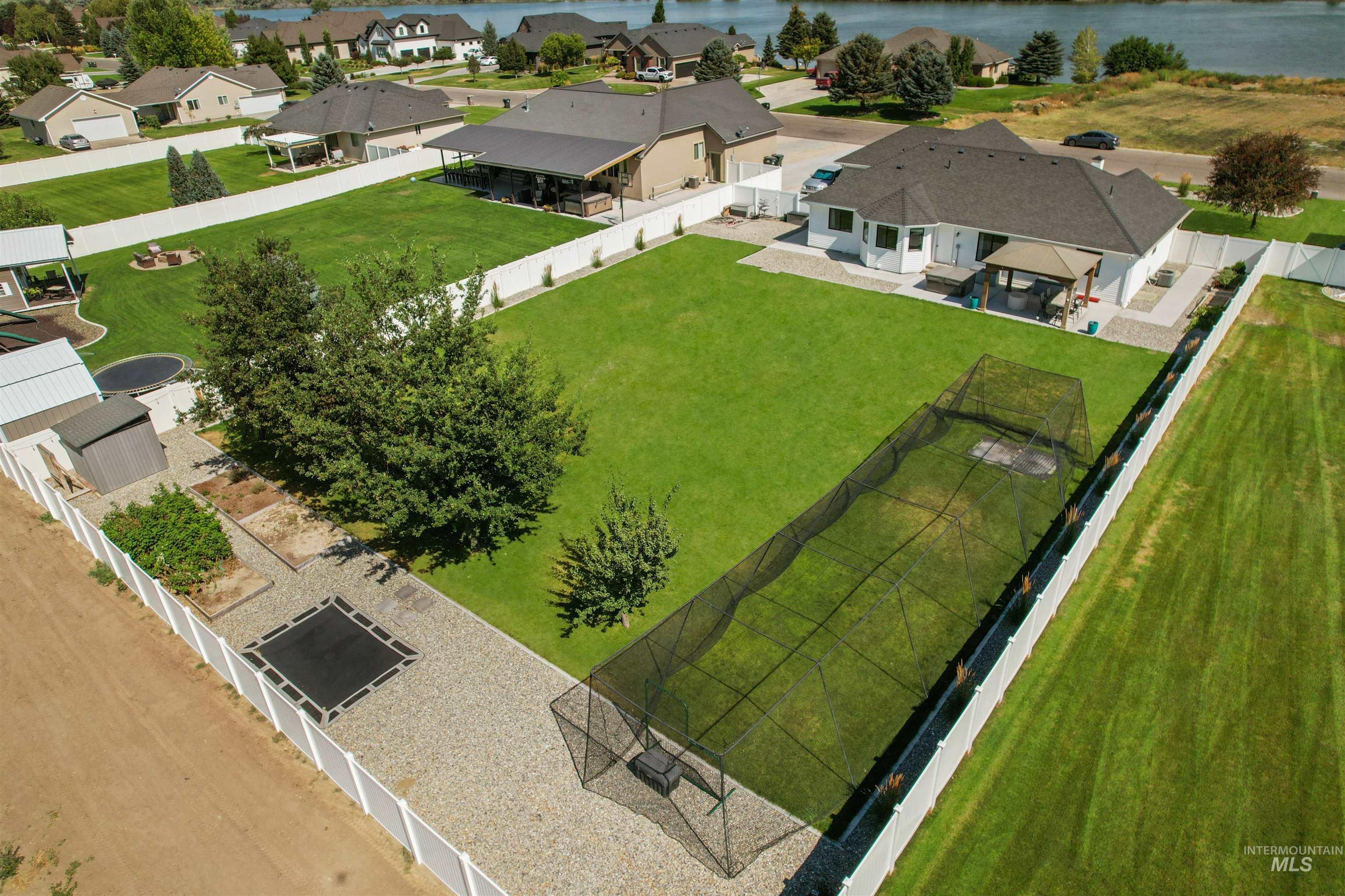 Aerial view of residential area featuring a nearby body of water