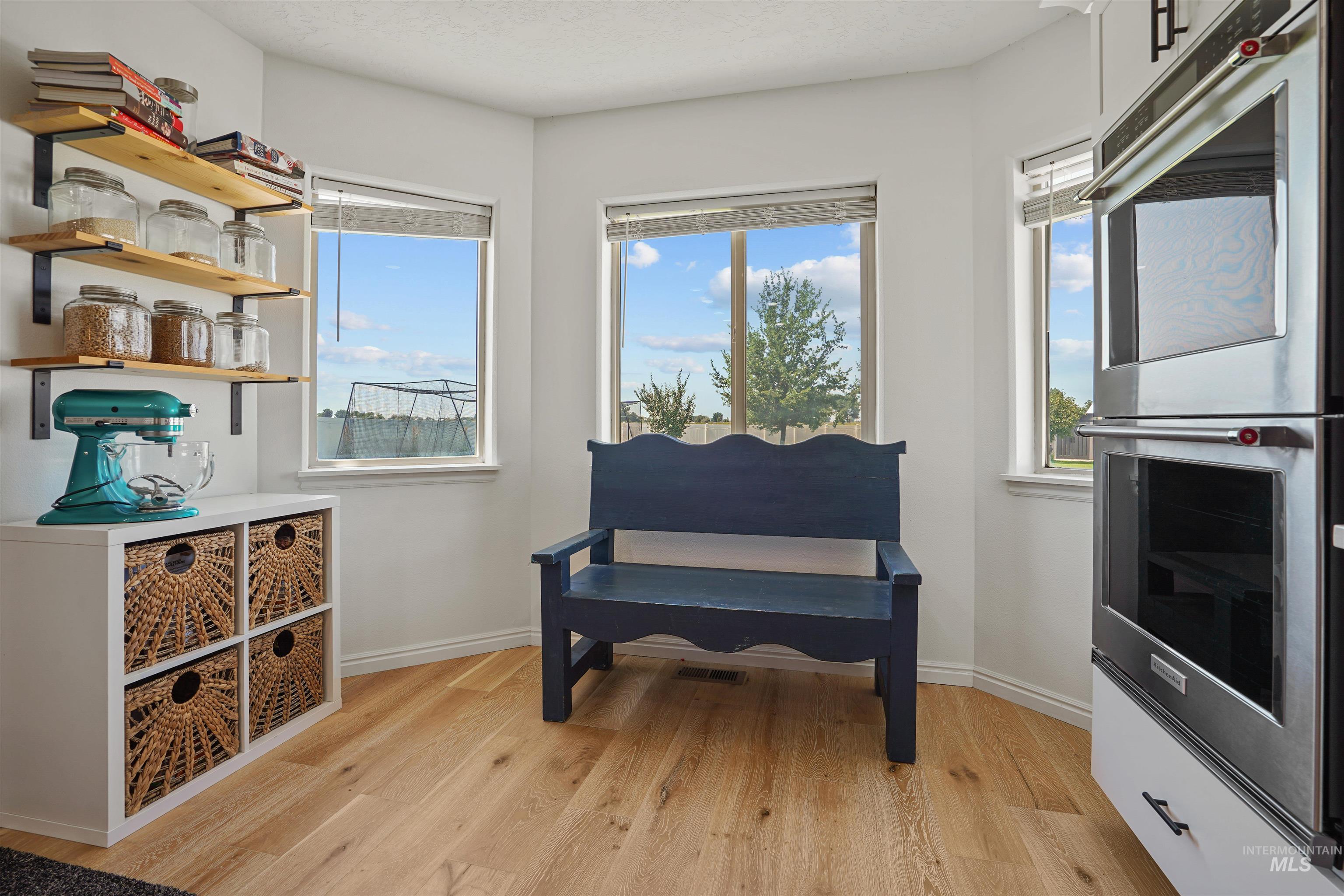 Living area featuring baseboards and light wood-style floors