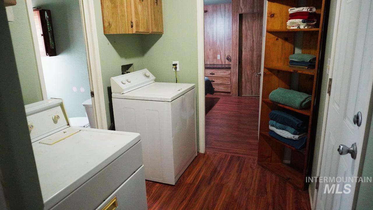 Laundry room featuring dark wood finished floors and separate washer and dryer