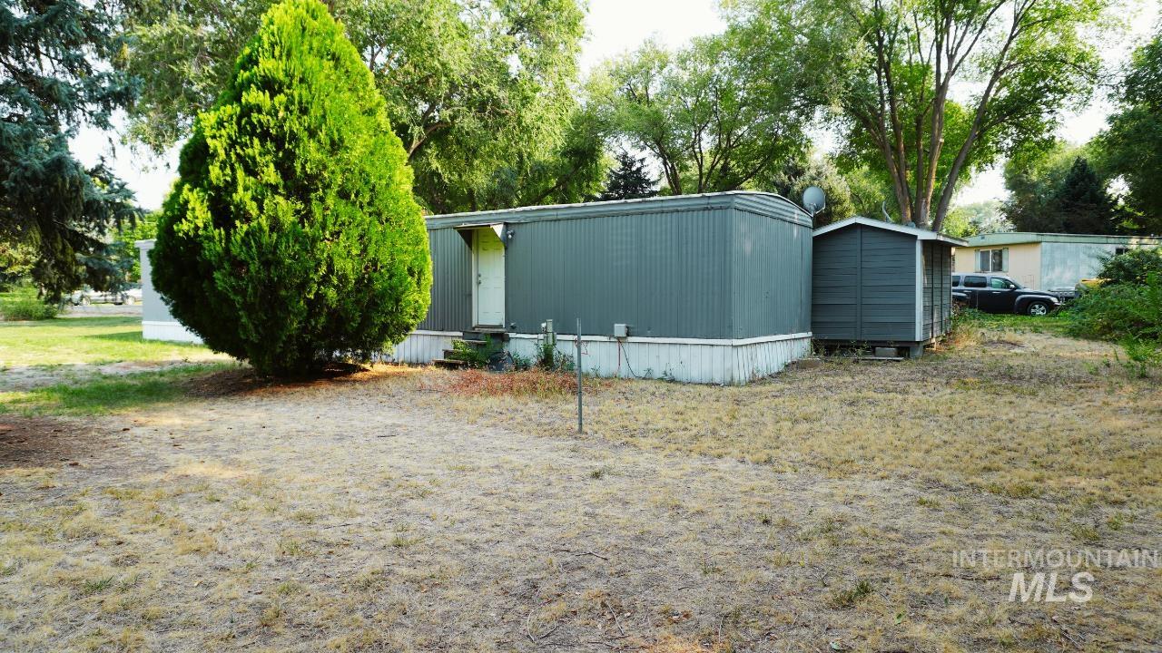 View of home's exterior with a storage unit