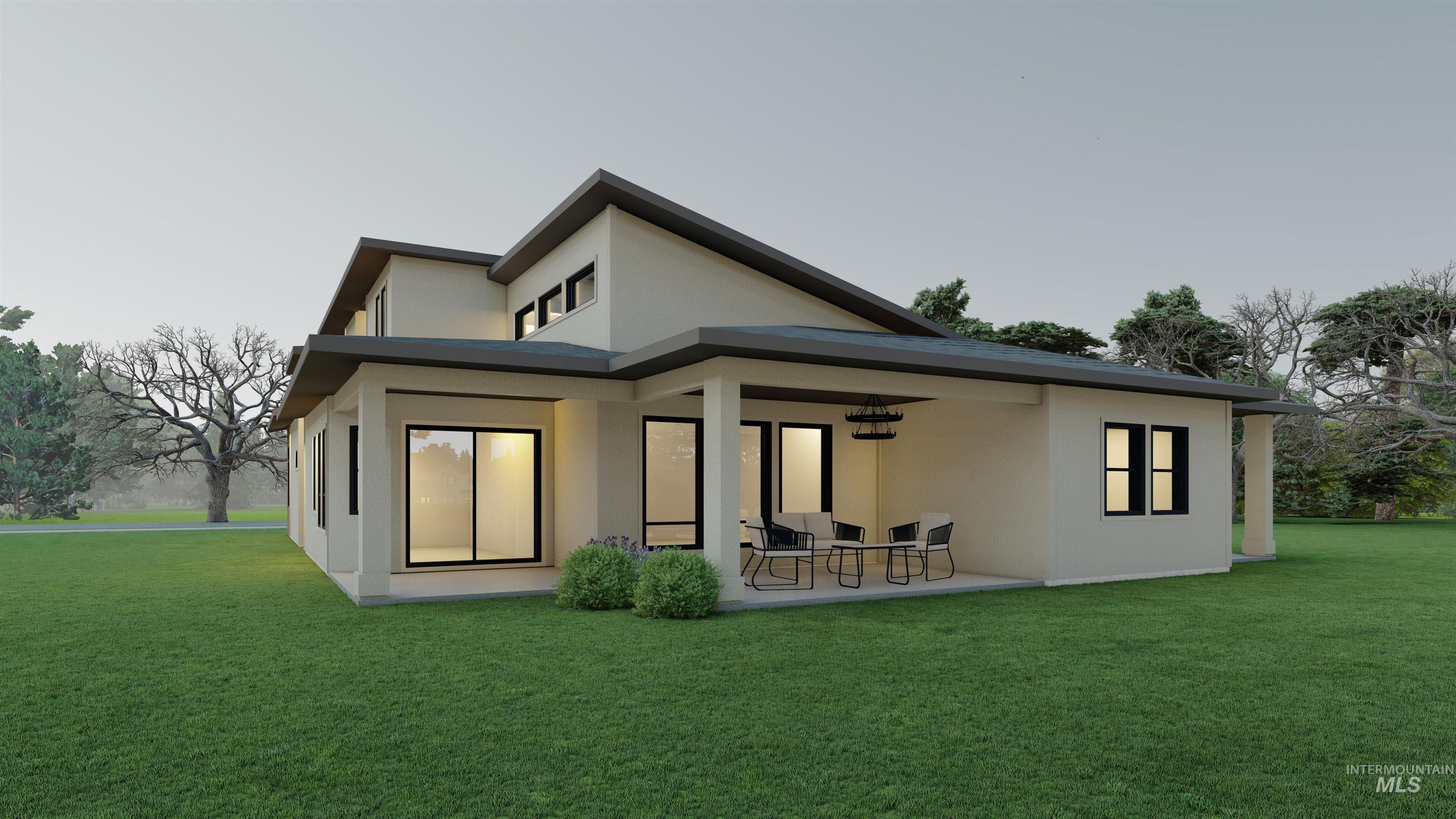 Rear view of property featuring stucco siding, a yard, and a patio area