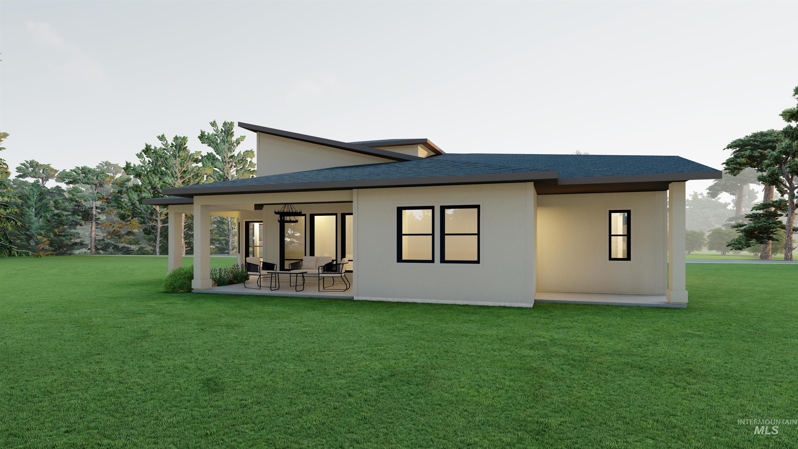 Rear view of house with a yard, stucco siding, a patio, and roof with shingles