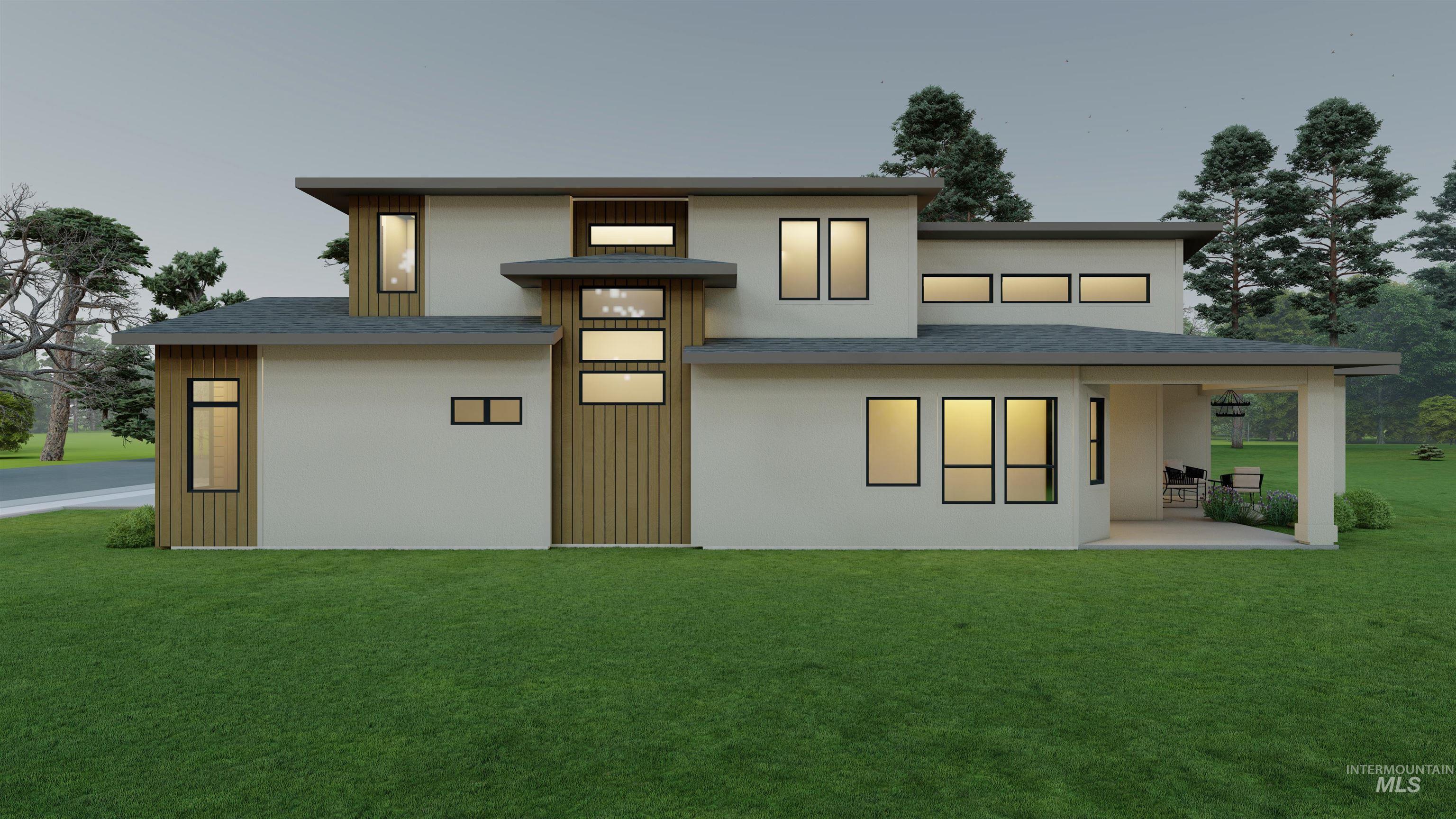 Back of house featuring a lawn, a shingled roof, a patio, and stucco siding