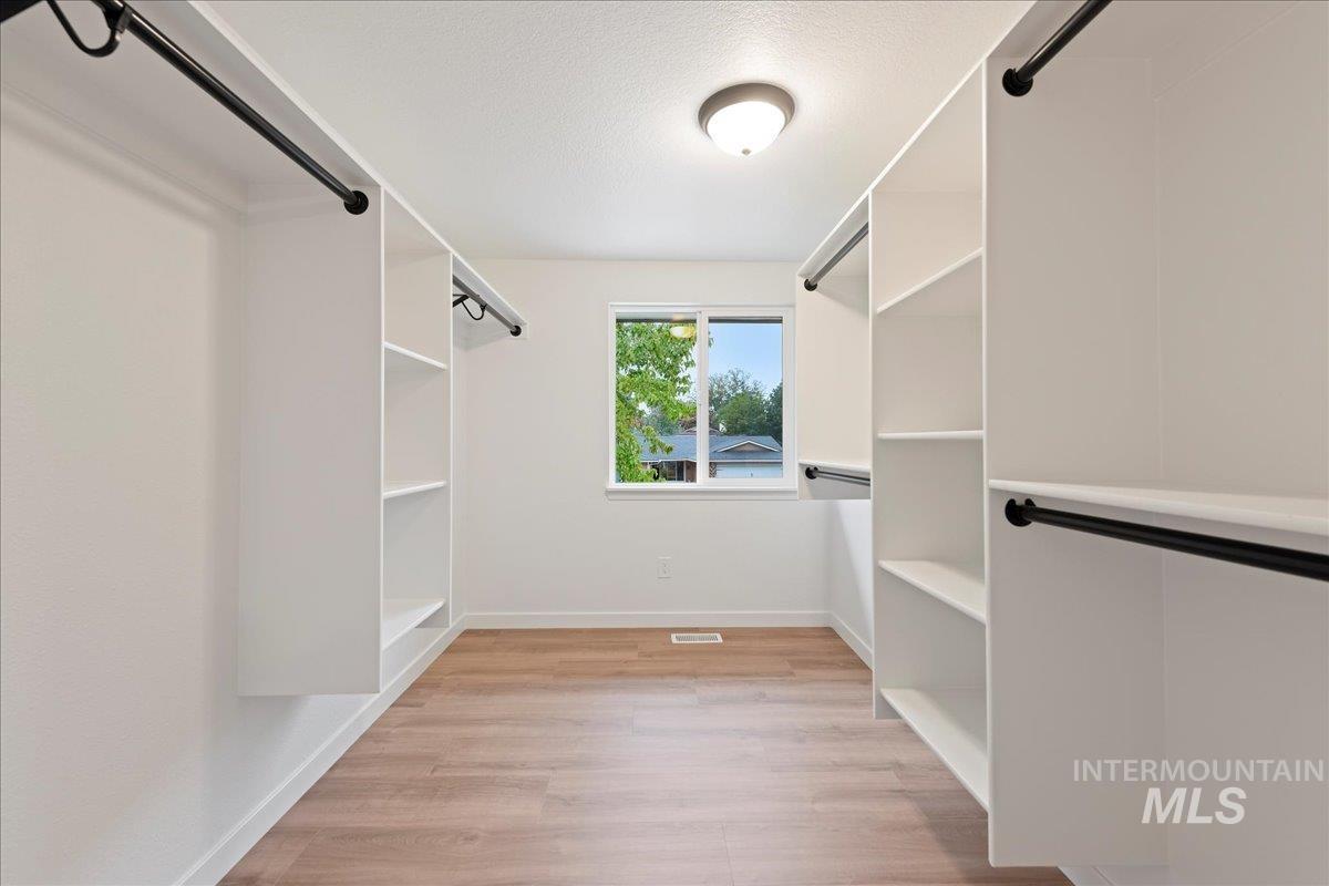 Walk in closet featuring light wood finished floors