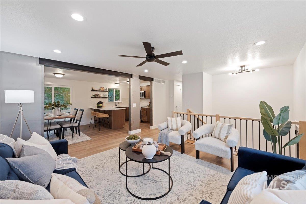 Living area featuring light wood finished floors and recessed lighting