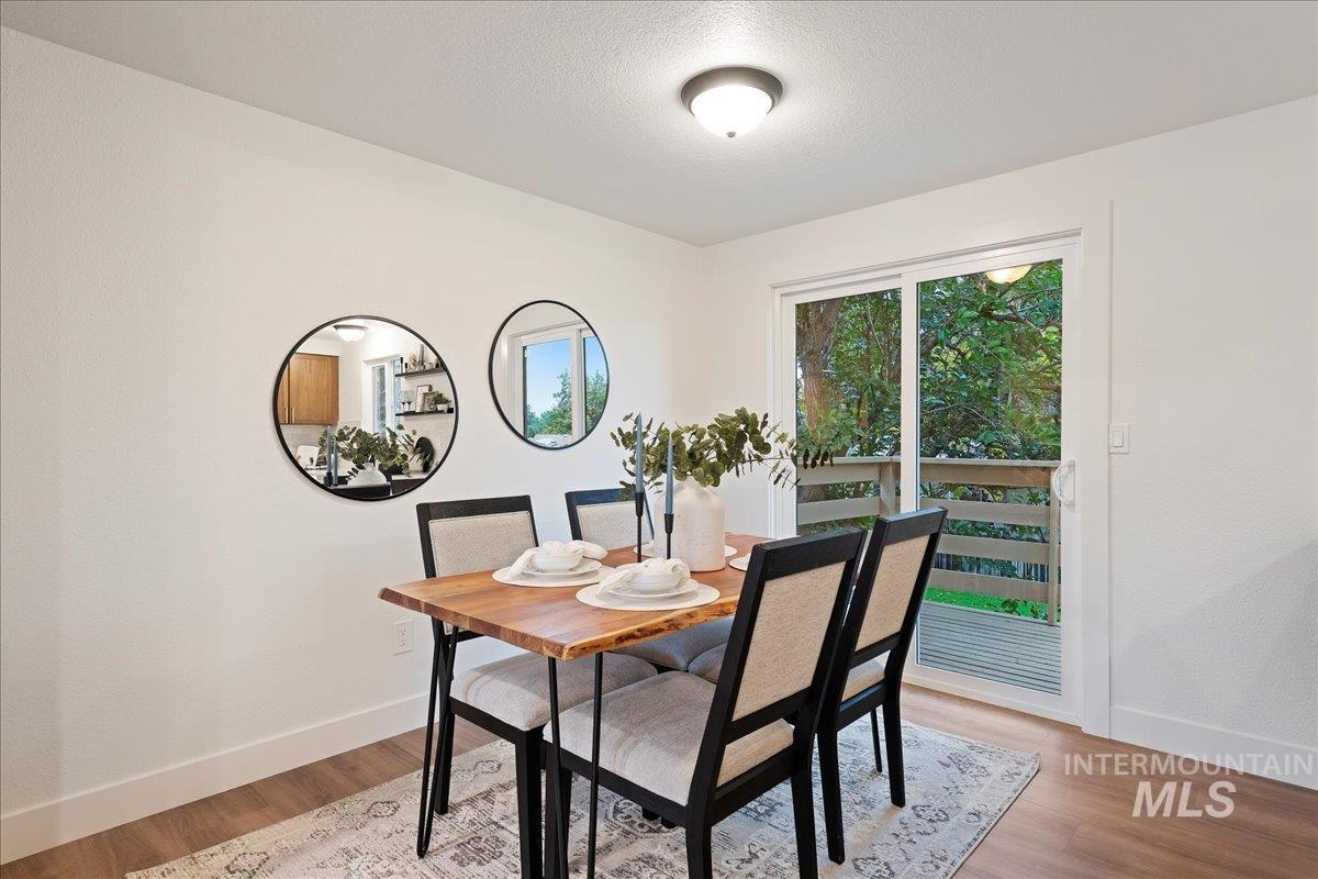 Dining room featuring light wood-style floors and a textured ceiling