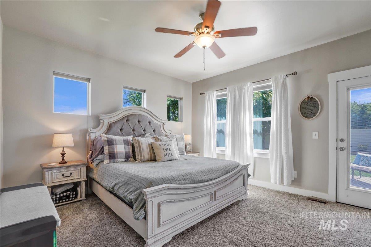 Bedroom featuring carpet flooring, access to outside, and a ceiling fan