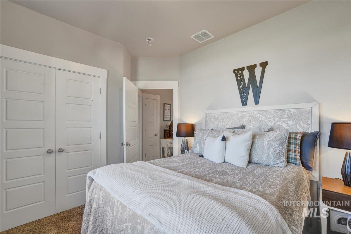 Carpeted bedroom featuring a closet