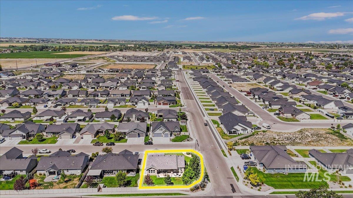 Aerial view of residential area featuring property boundaries highlighted