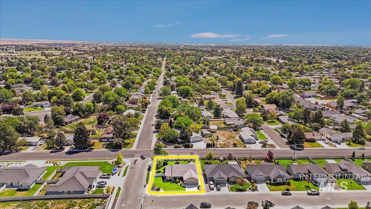 Aerial perspective of suburban area featuring property boundaries highlighted