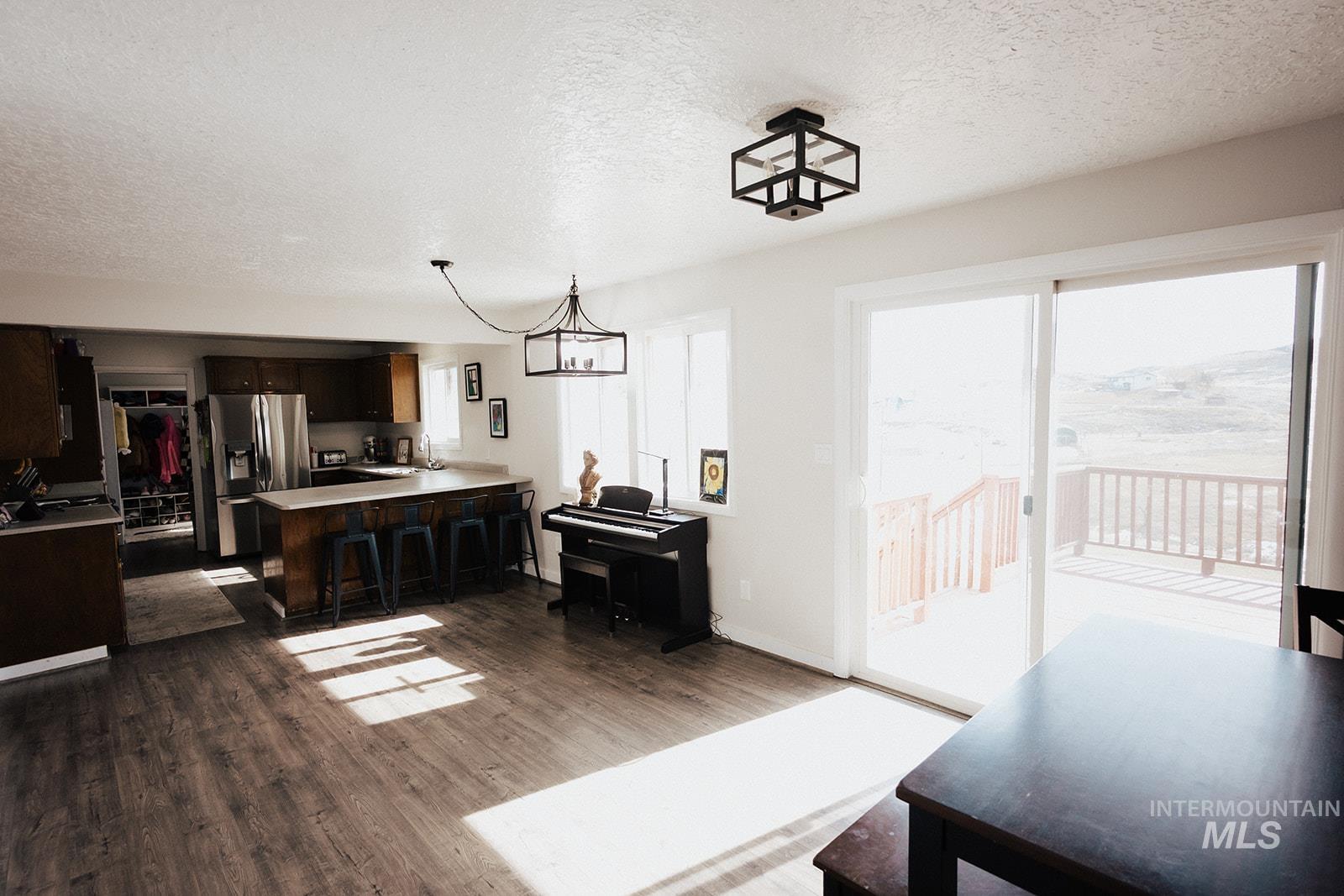Living room featuring a textured ceiling and dark wood finished floors