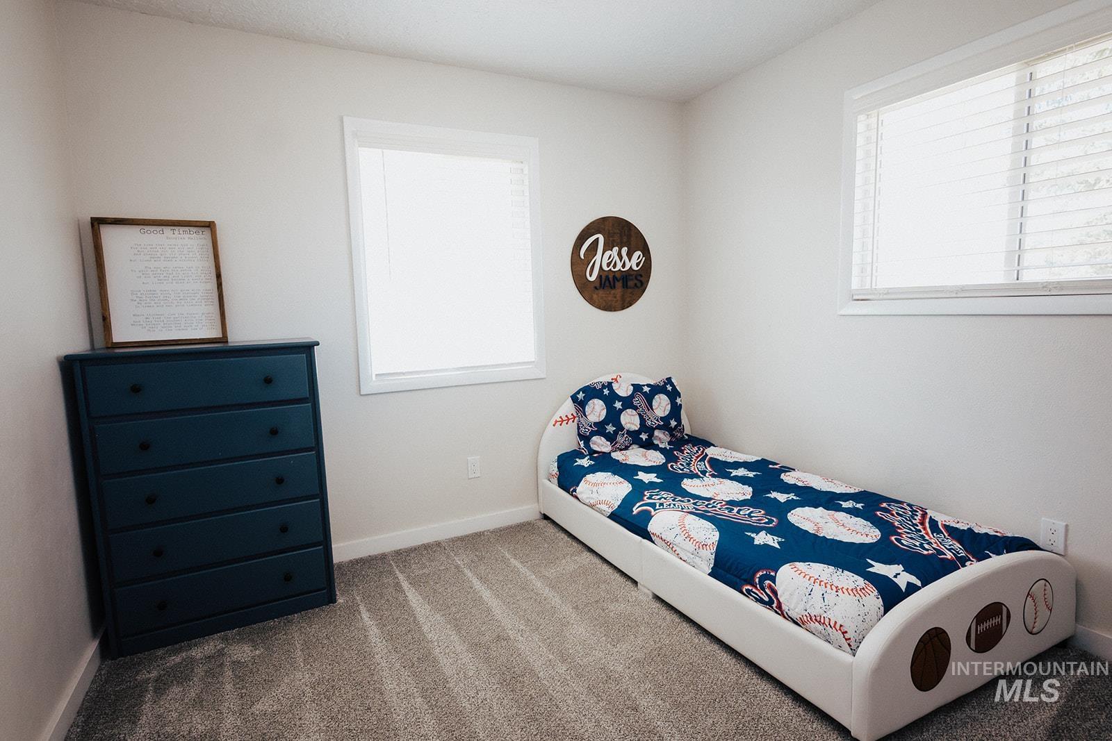 Carpeted bedroom with multiple windows