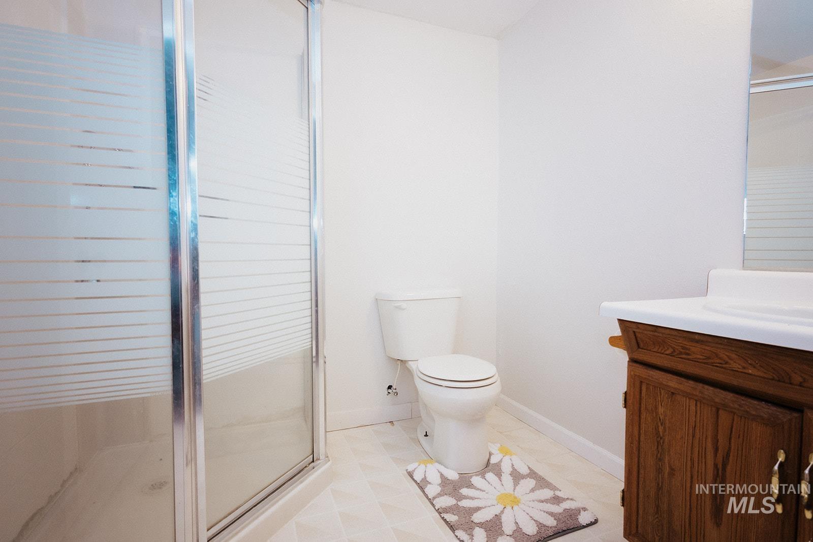 Full bathroom with vanity and a stall shower