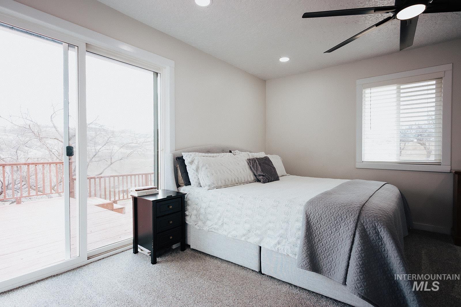 Bedroom with carpet flooring, access to outside, a textured ceiling, recessed lighting, and a ceiling fan