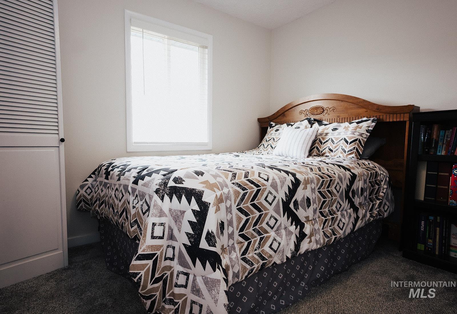 Bedroom featuring dark carpet