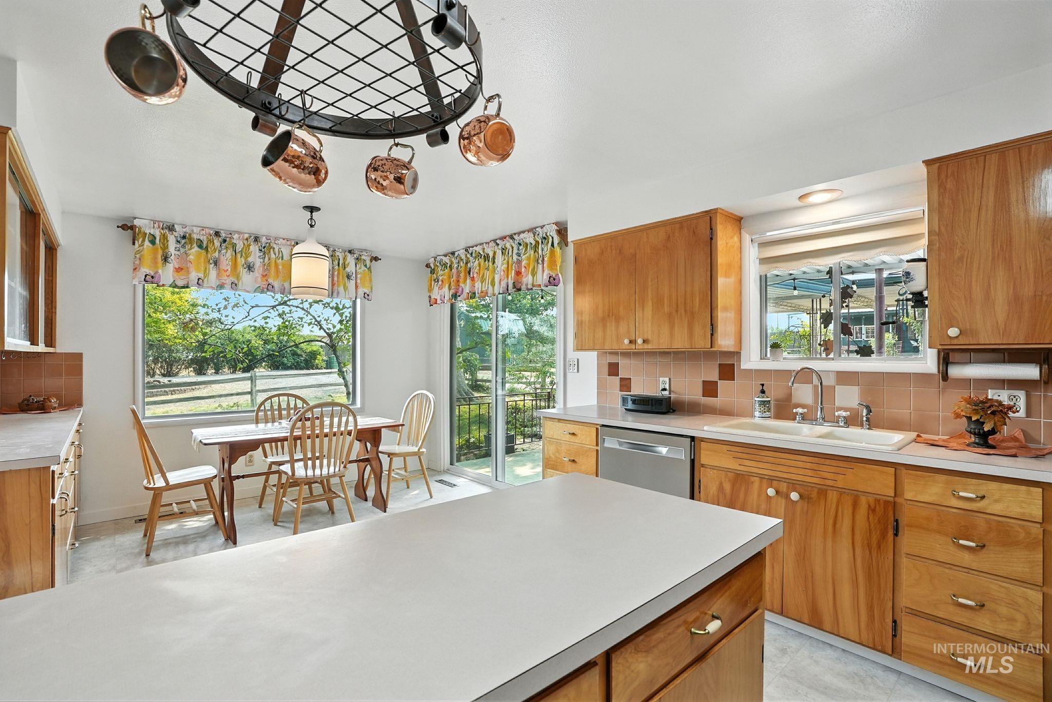 Kitchen featuring tasteful backsplash, brown cabinetry, and light countertops