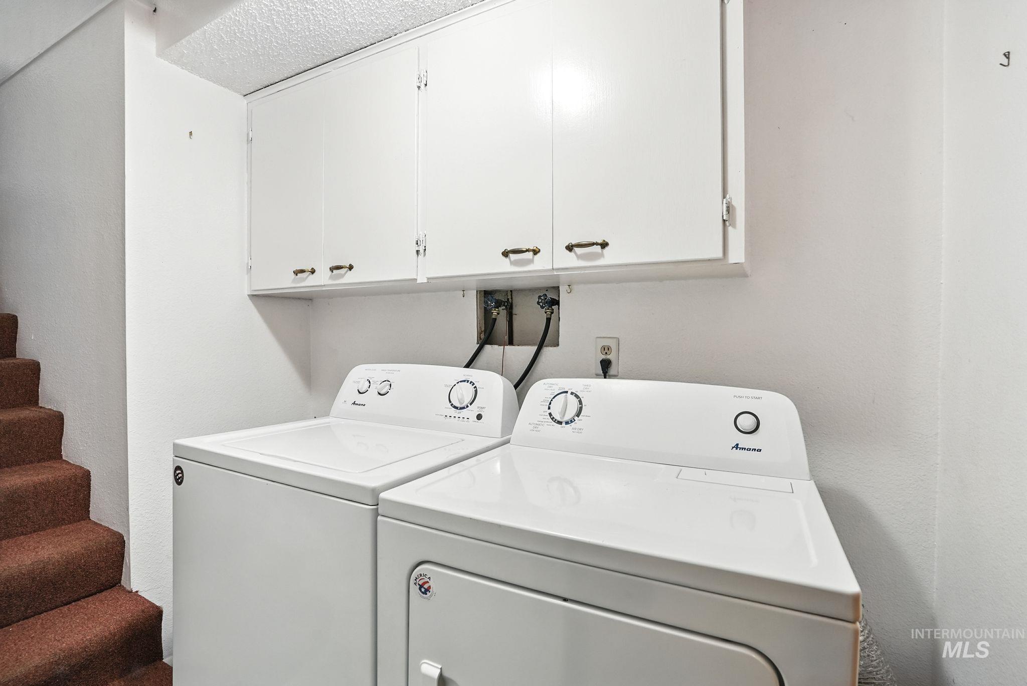 Laundry room with cabinet space and washer and dryer