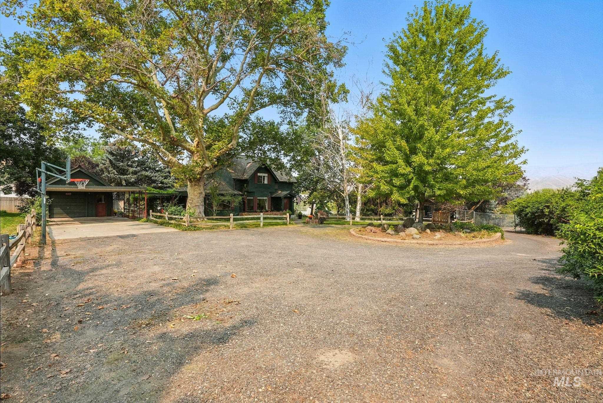 View of front of property featuring driveway and an attached carport