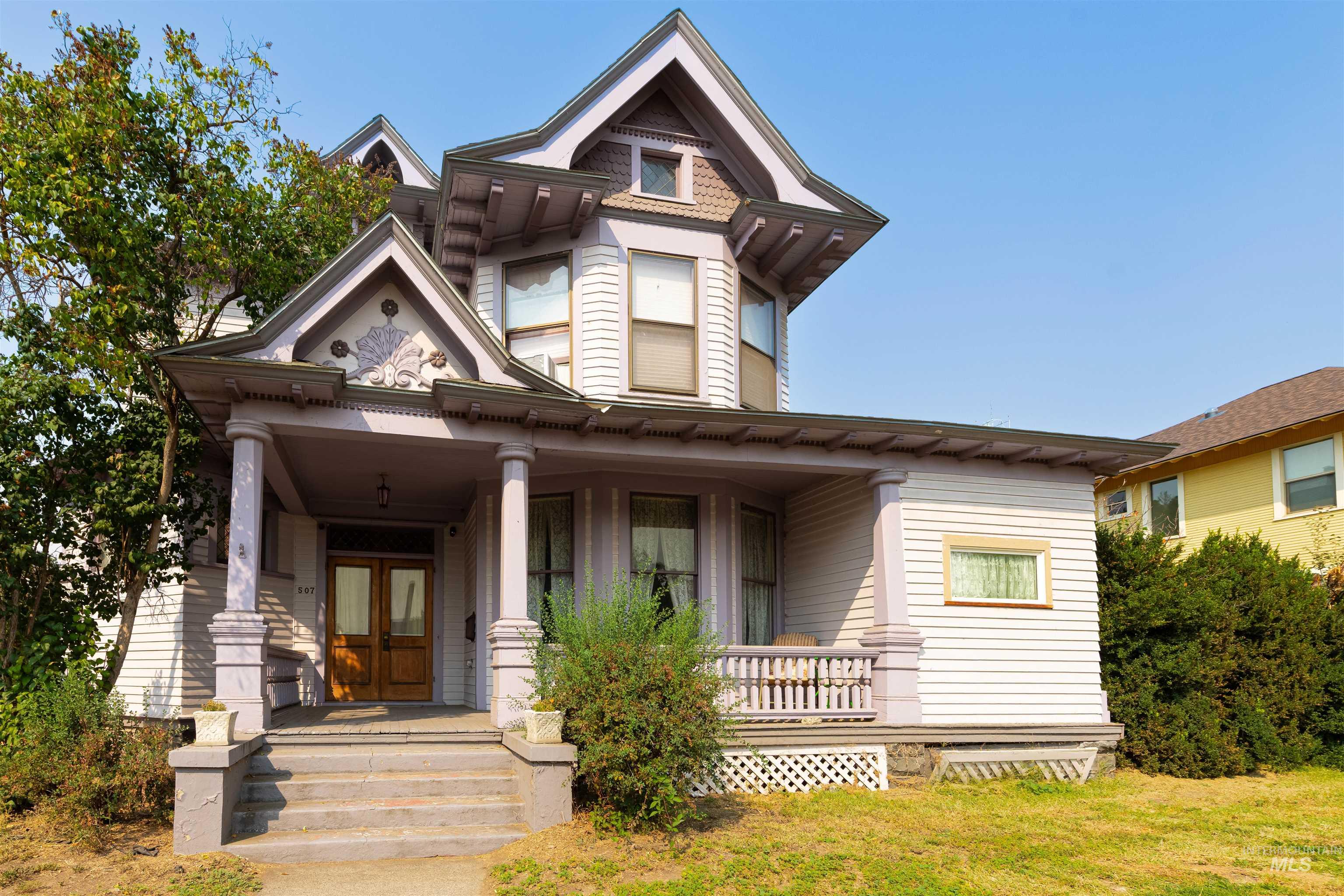 Victorian-style house featuring covered porch and french doors