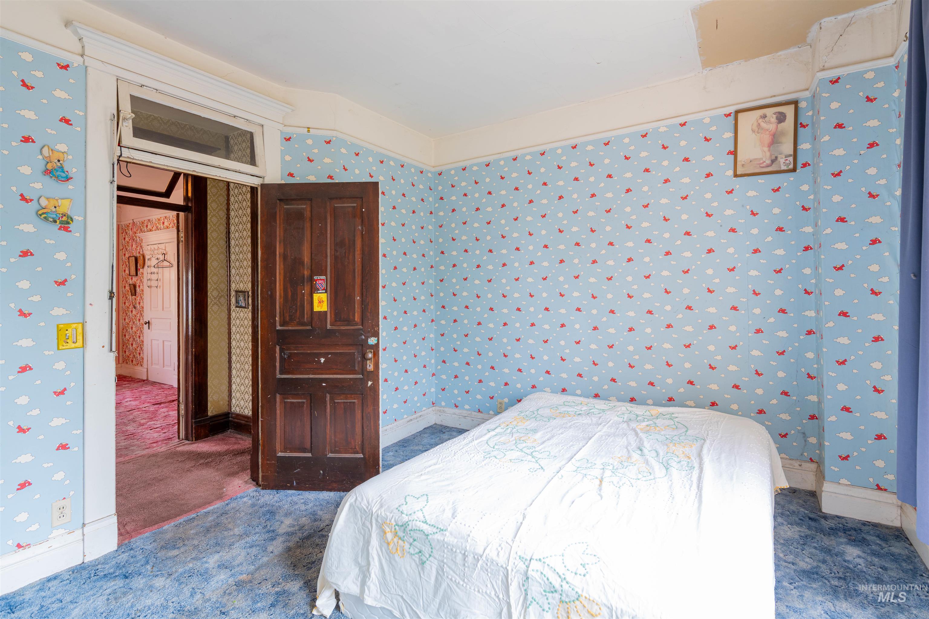 Bedroom featuring wallpapered walls and carpet flooring