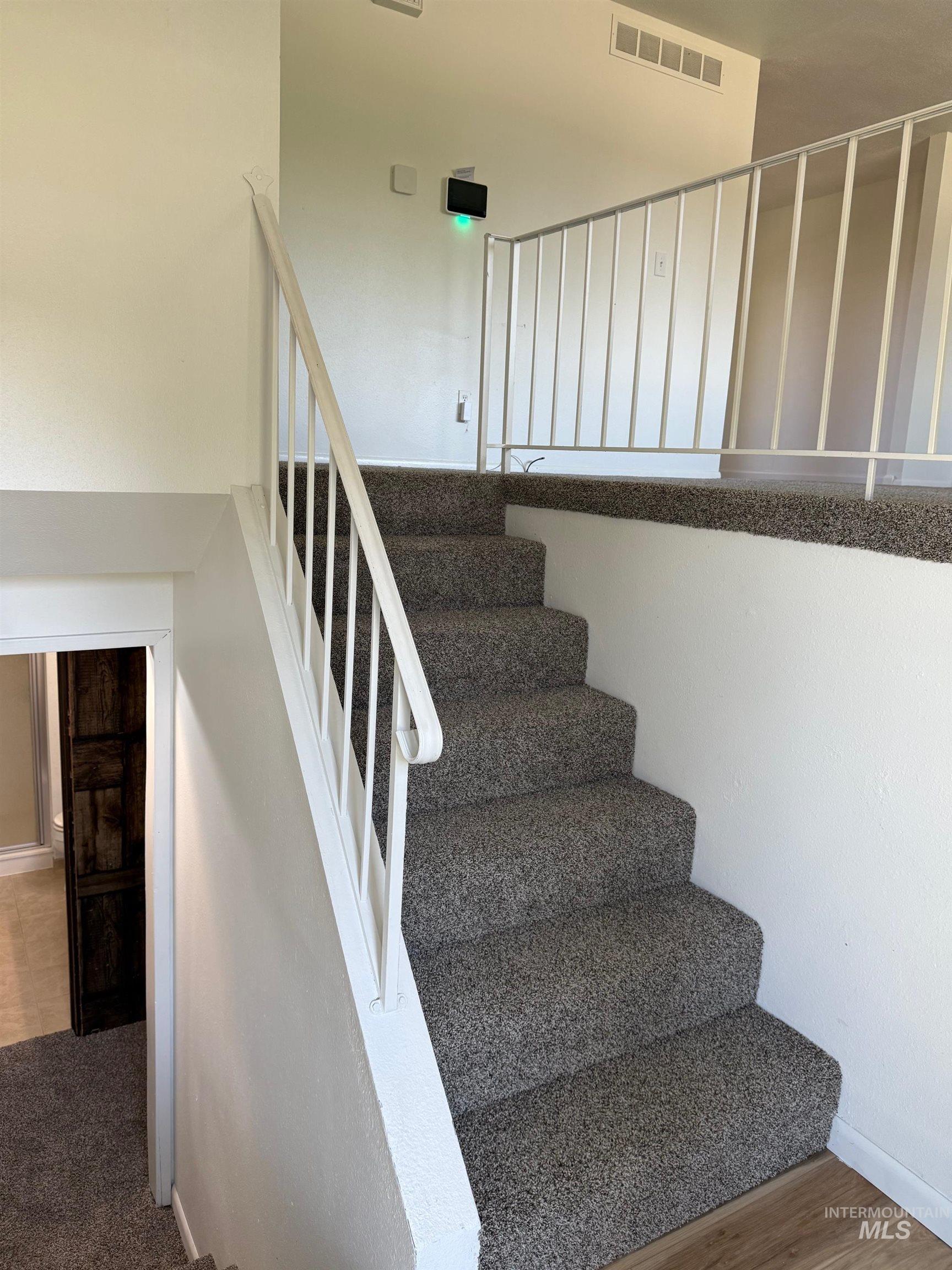 Stairs featuring baseboards and wood finished floors