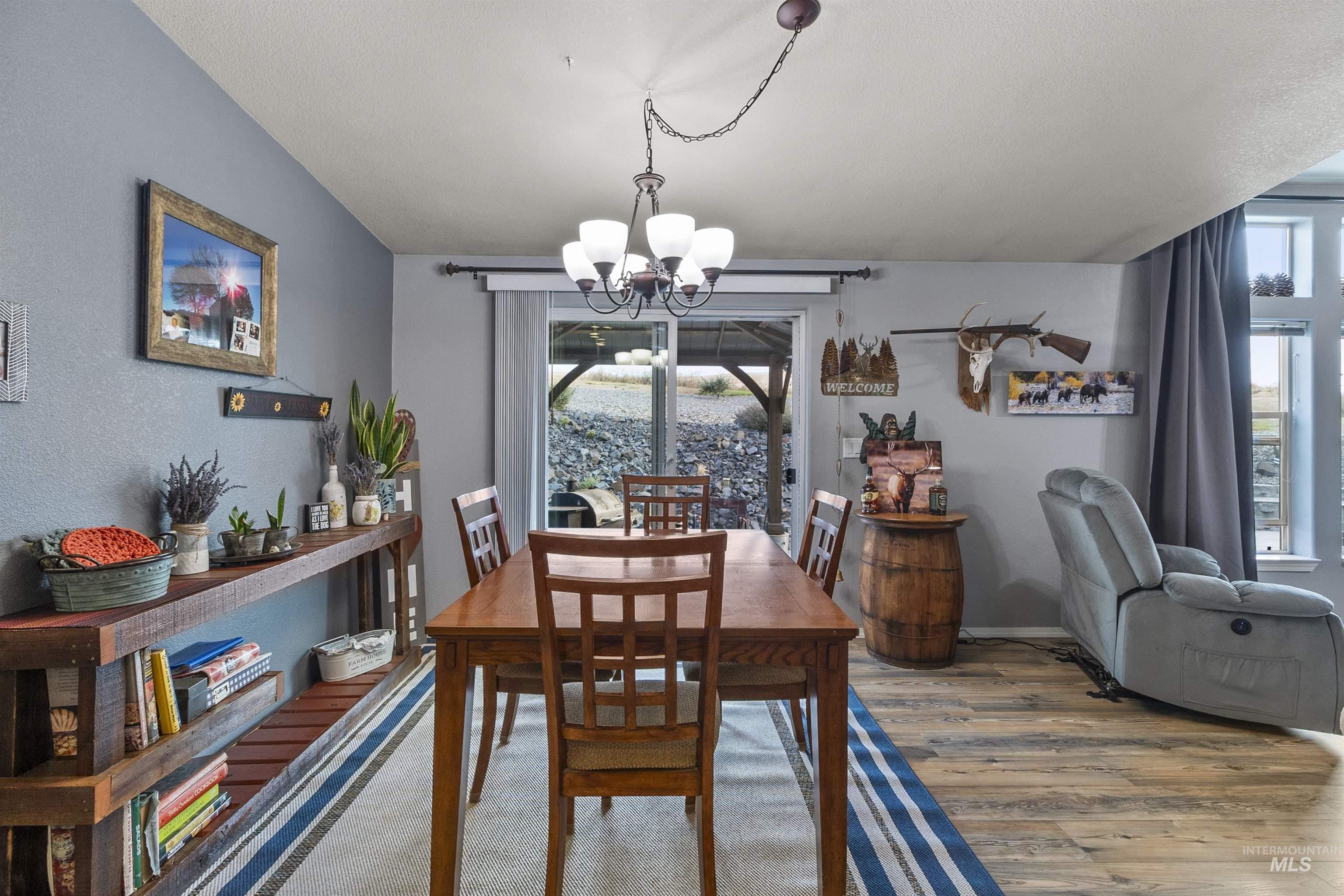 Dining space featuring wood finished floors and a chandelier